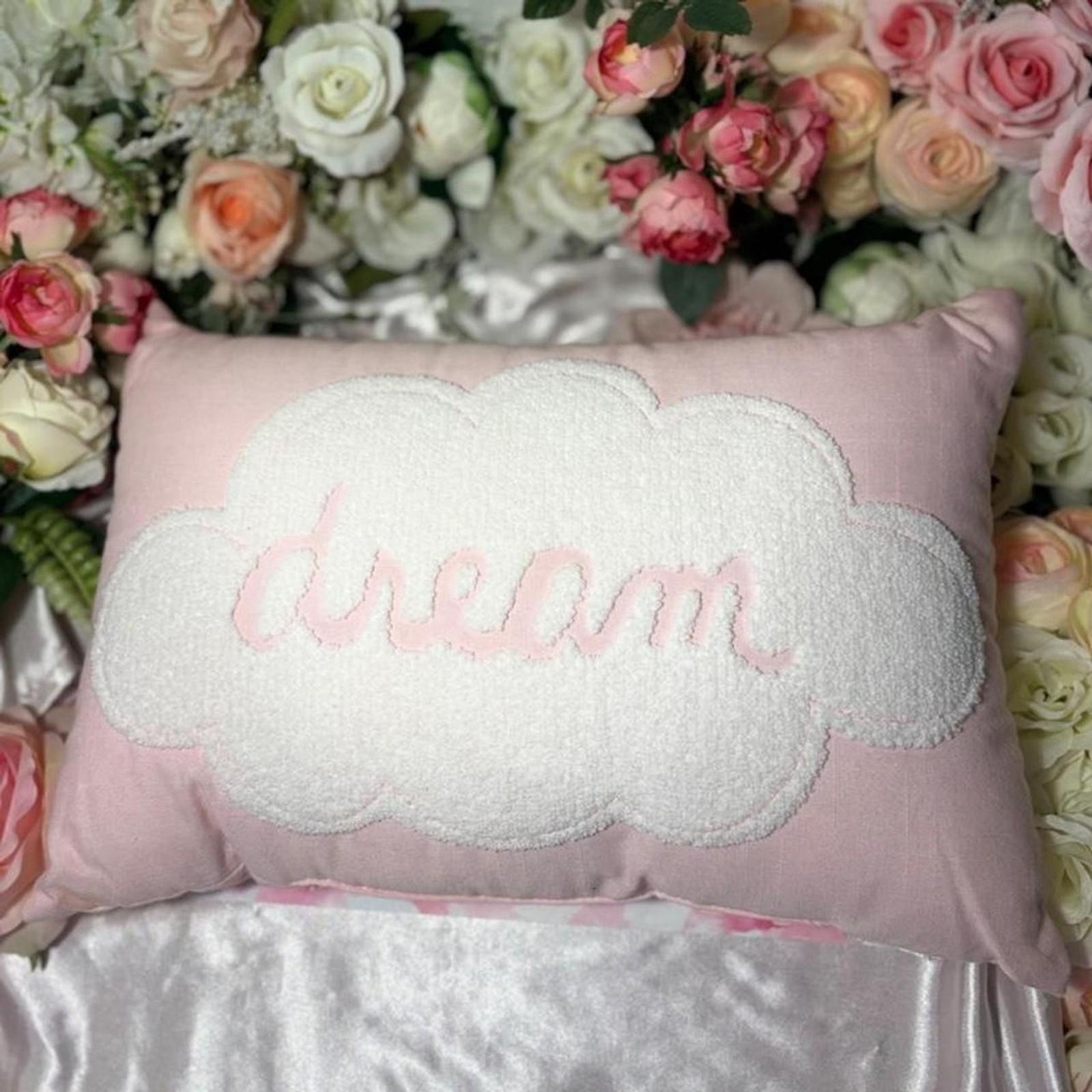 small pink and white decorative pillow (labeled dream)