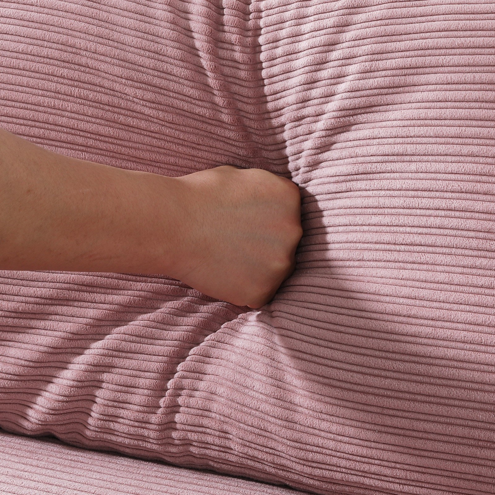 The 53-inch pink sofa offers a spacious layout in the small apartment, easily