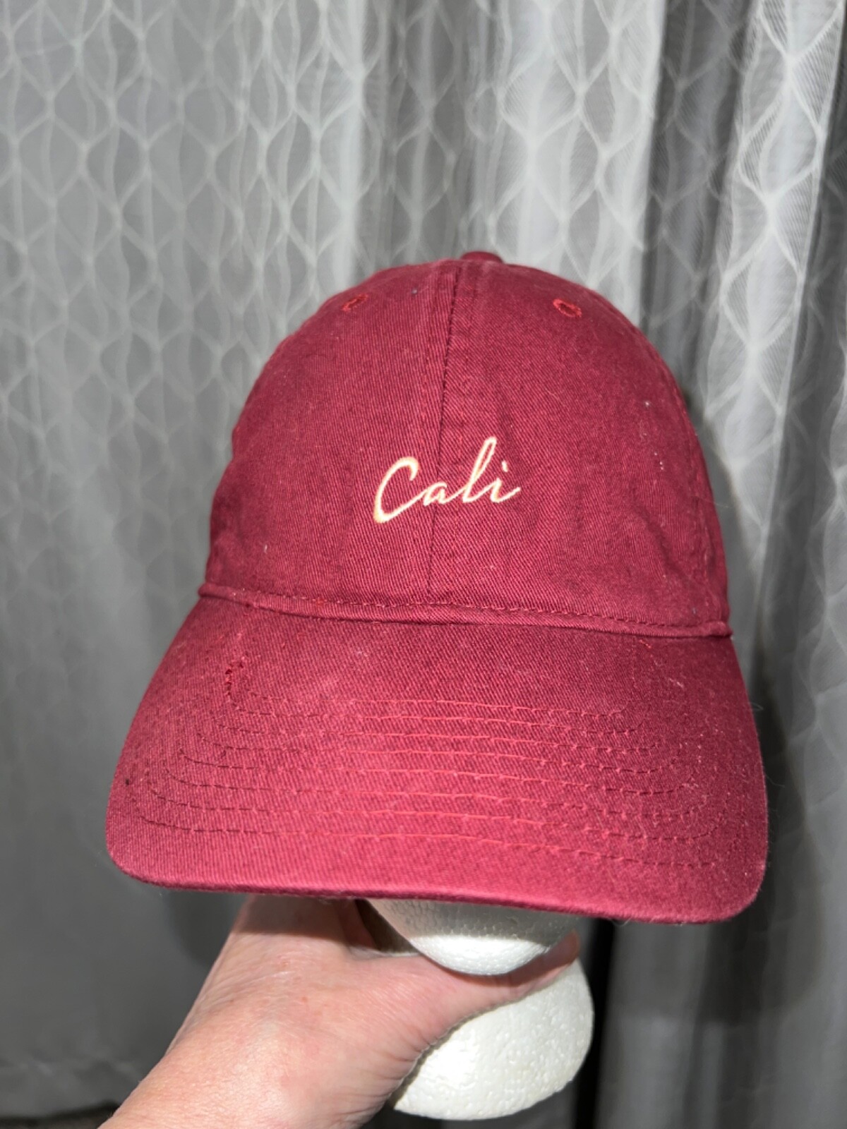 Maroon Cotton hat with Cali in yellow cream front embroidery. 100% Cotton Adj