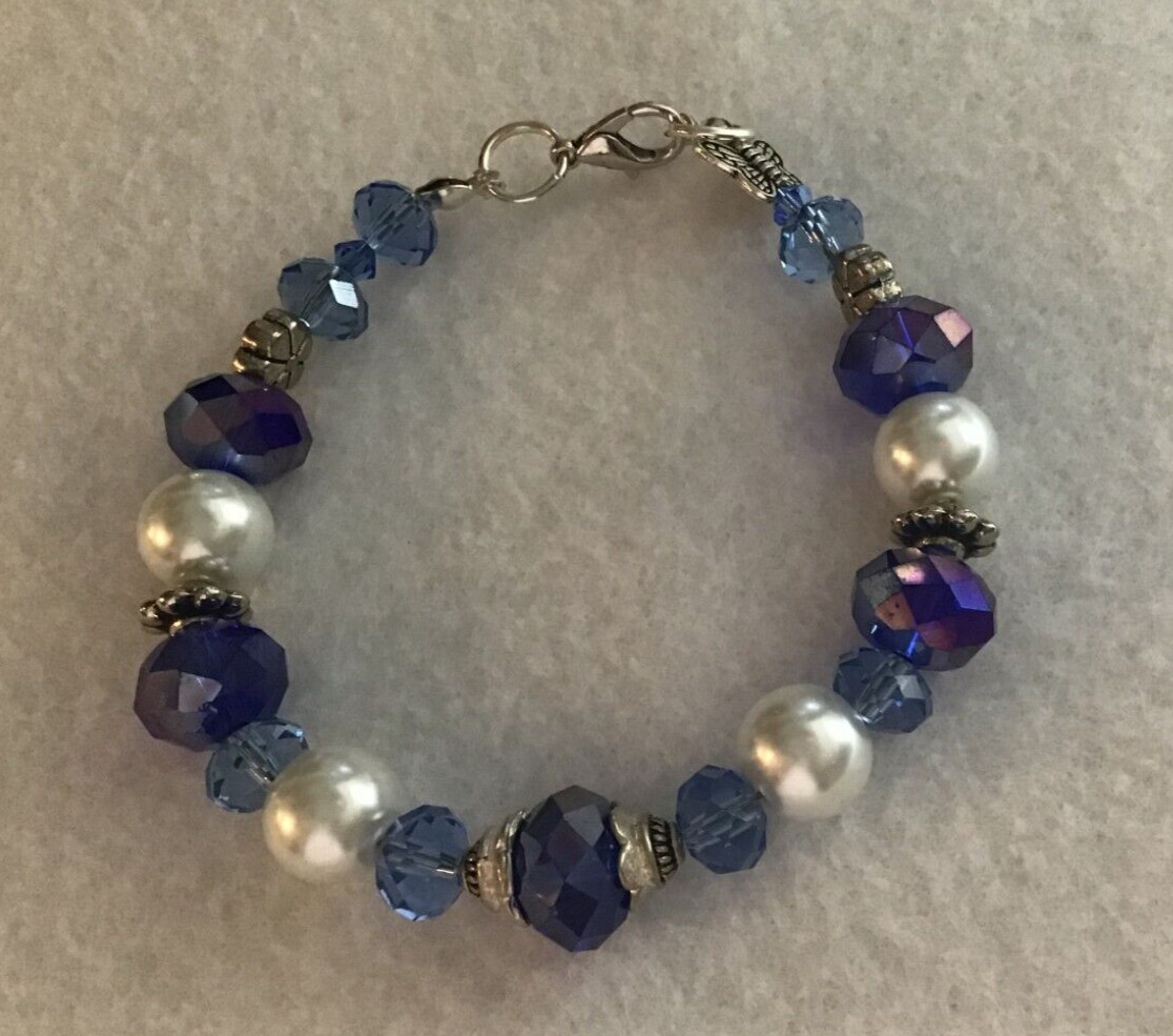 Beautiful bracelet w/blue glass AB beads & pearls & silver findings.  Elegant !