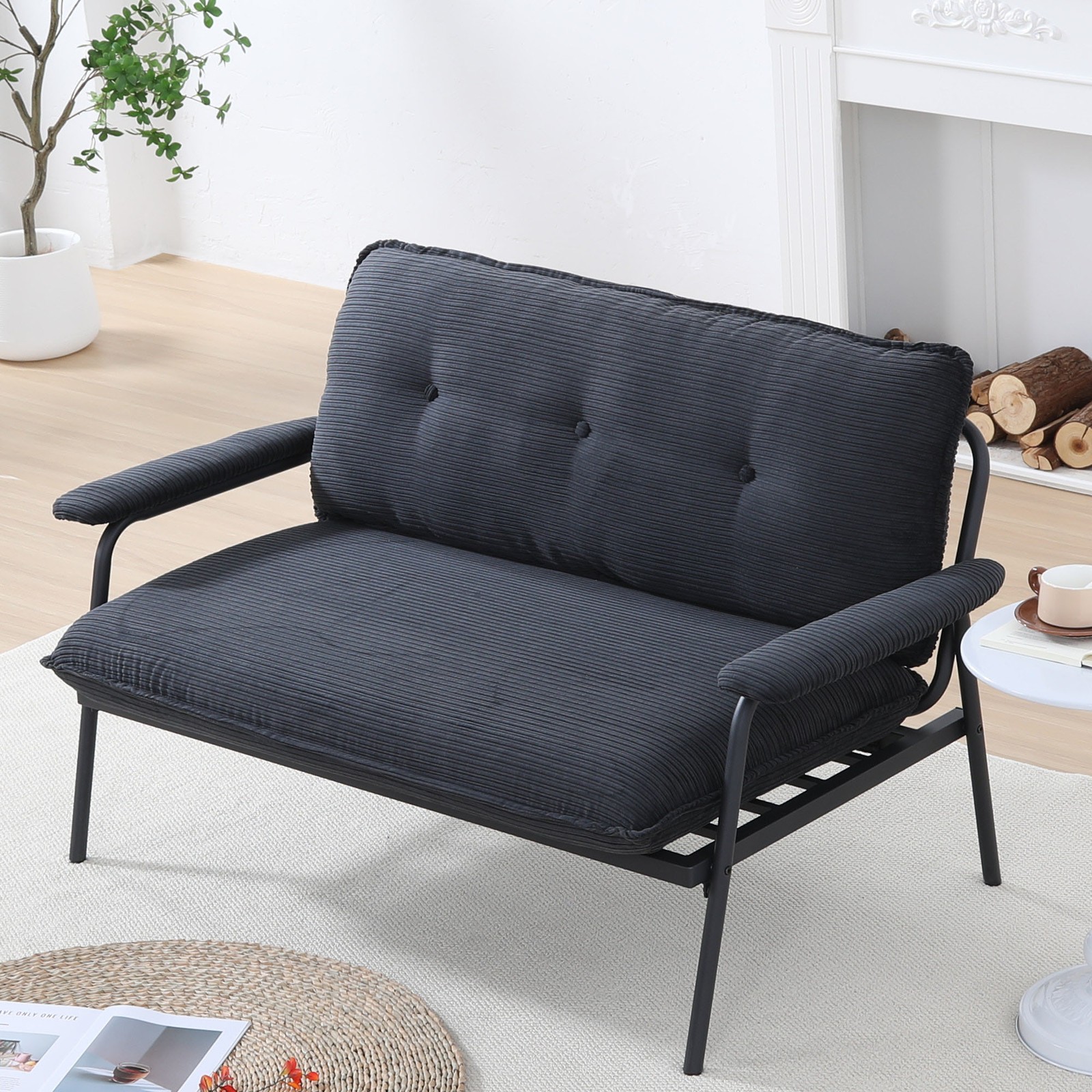 The 53-inch black sofa offers a spacious layout in the small apartment, easily
