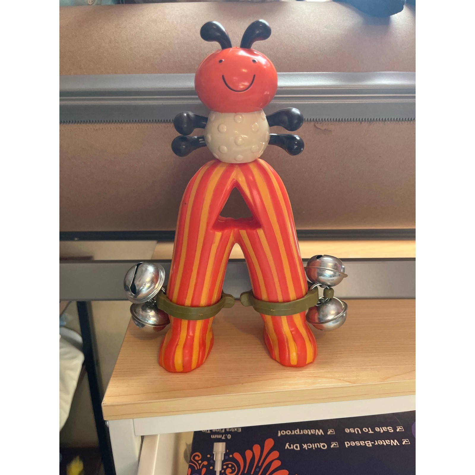 B Toys Parum Pum Pum Ant Jingle Bell Shaker Musical Toy Orange Yellow Striped