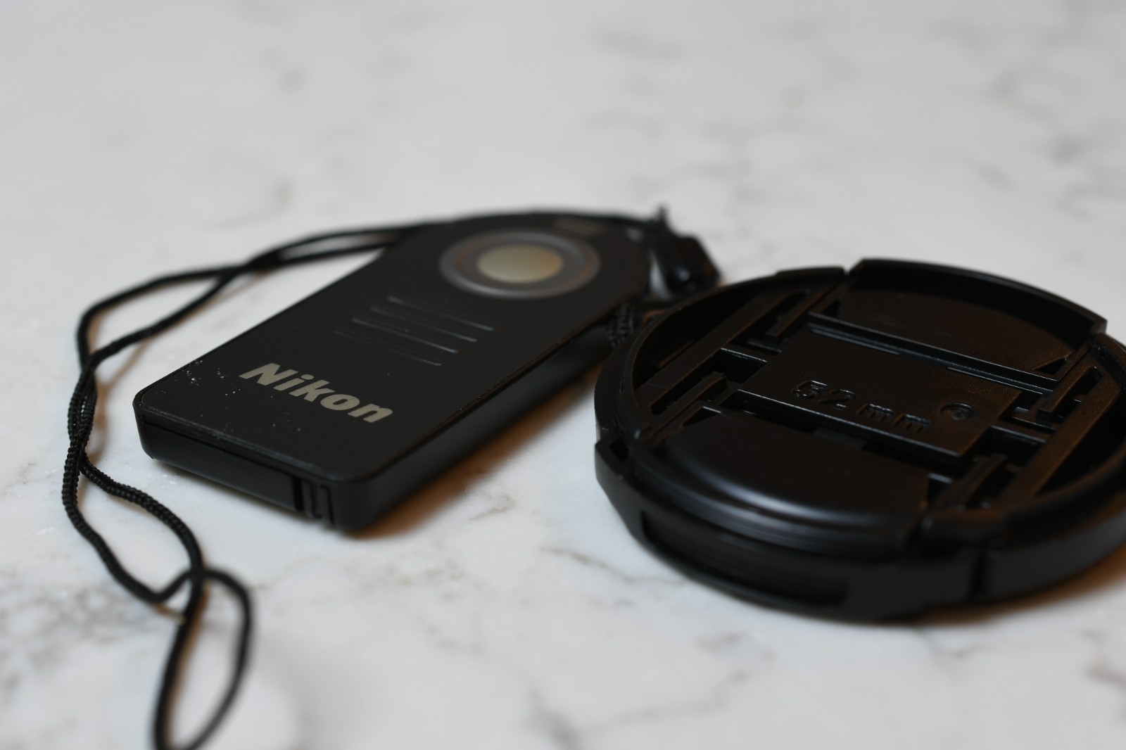 Nikon ML-L3 remote shutter release and 52mm lens cap with string attach