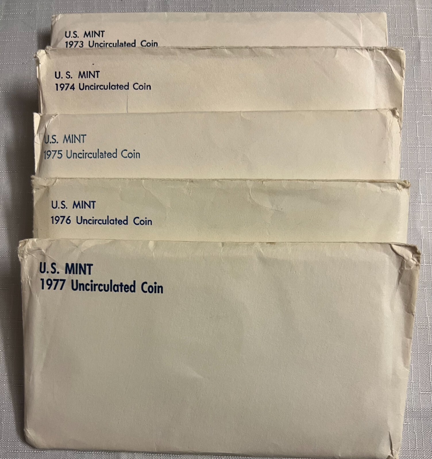 1973, 1974, 1975, 1976, 1977 US MINT SETS WITH BRILLIANT UNCIRCULATED COINS