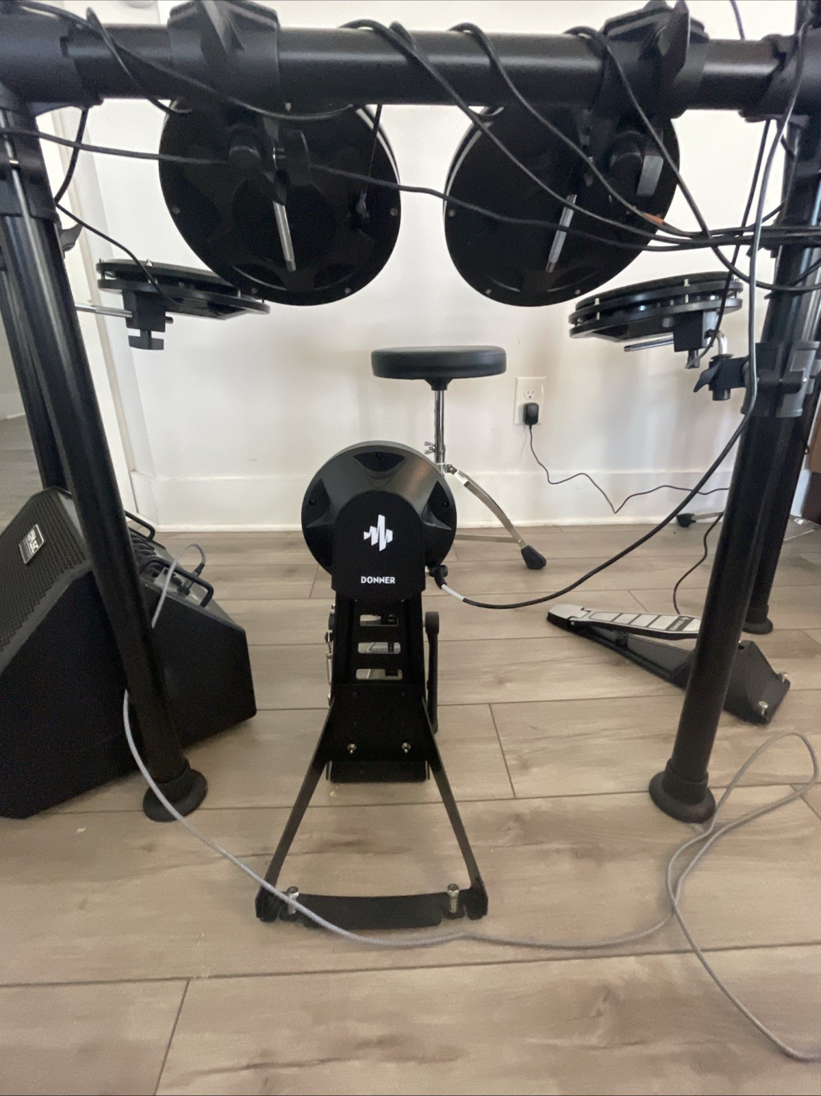Donner DED-200 Drum set with amplifier, drumsticks, table, and seat.