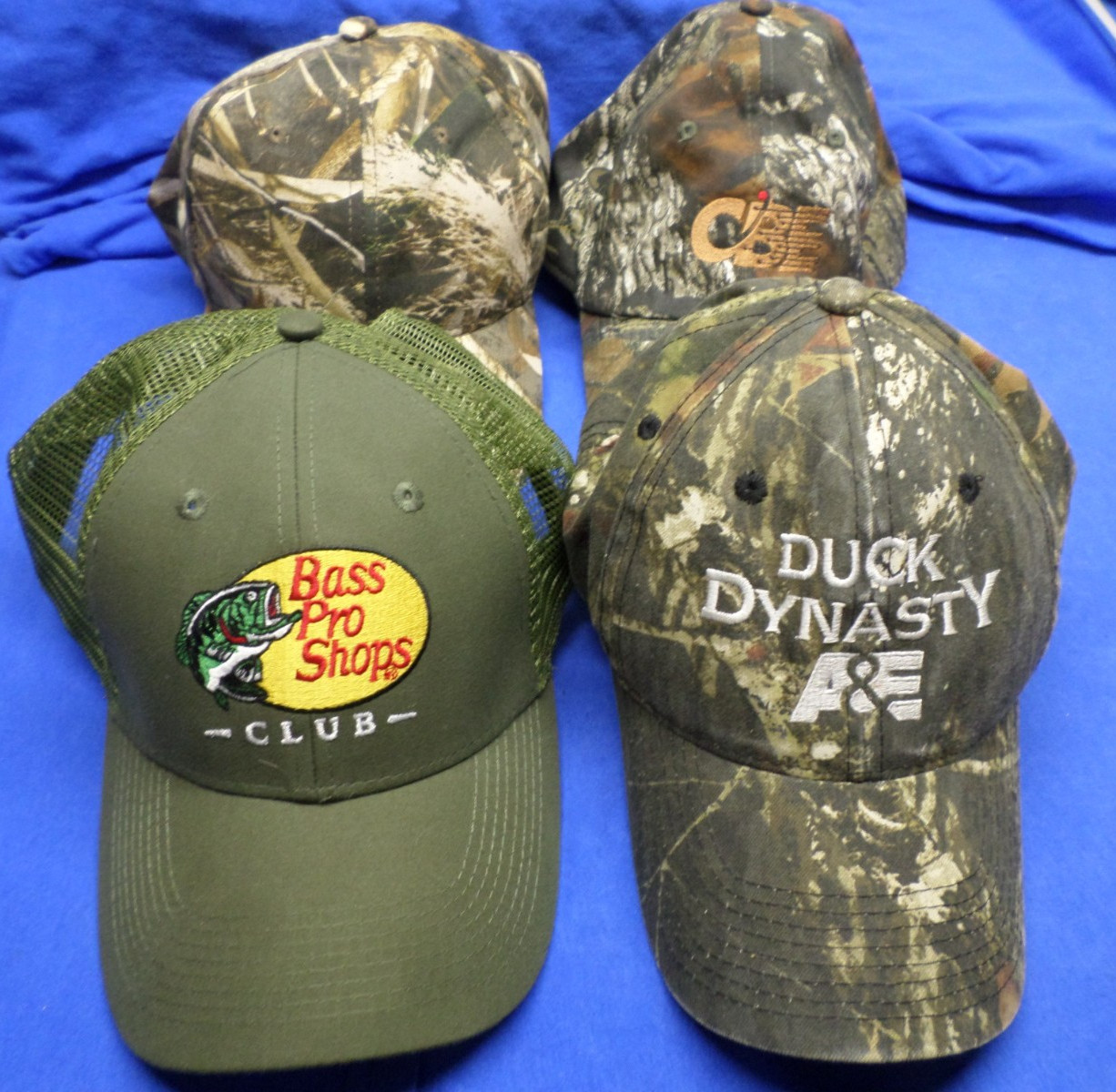 Lot of 4 Green and Camo Hats - Bass Pro Shops, Duck Dynasty, CBE, Trucker Cap