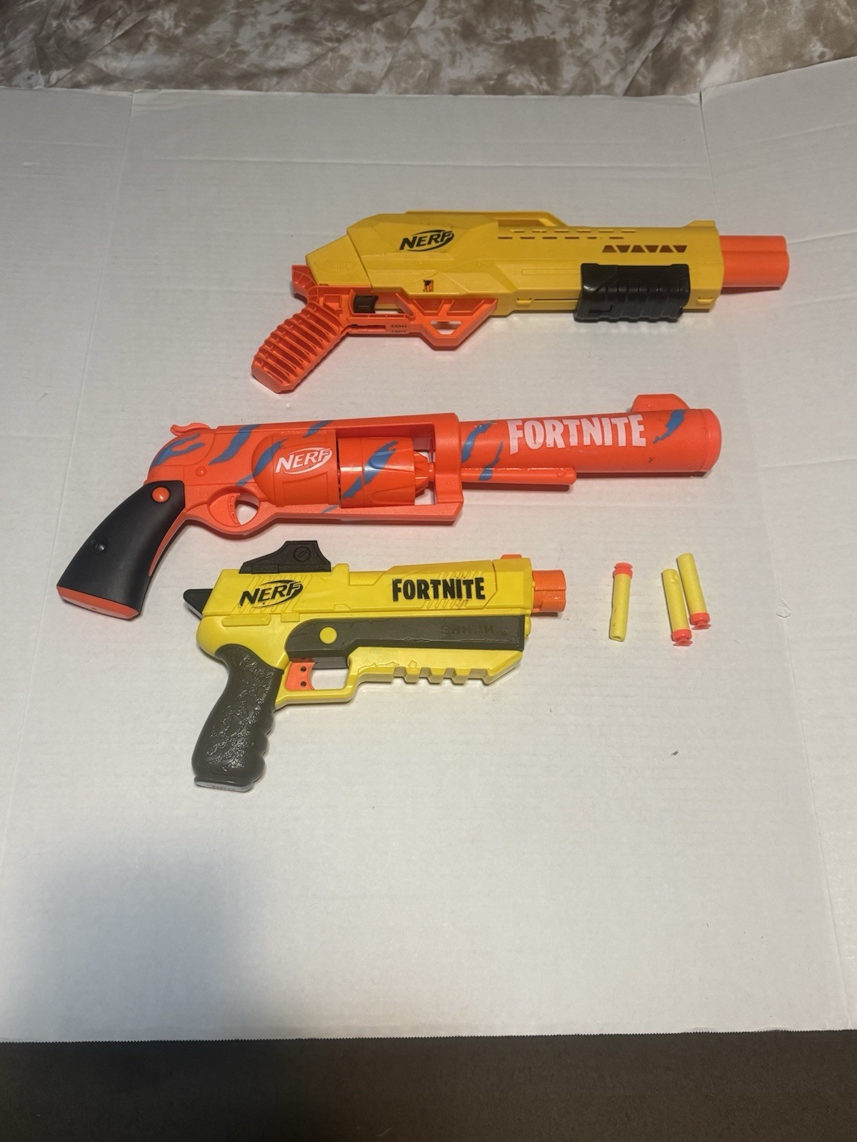Lot of 3 nerf guns with a few foam bullets 2 of them are Fortnite