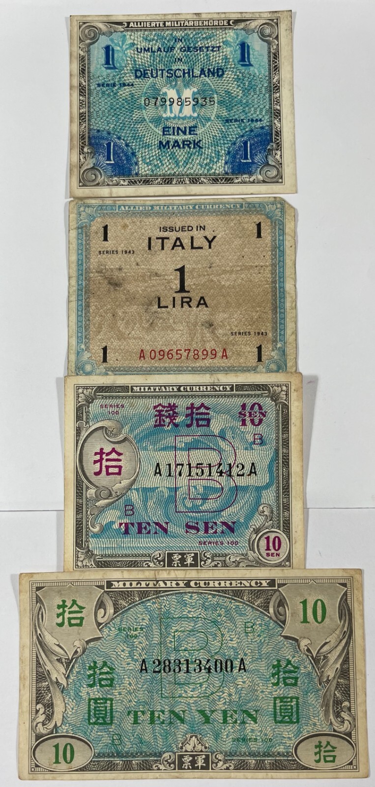 Military currency 8 different pcs. (#472) includes one US. Mixed quality.