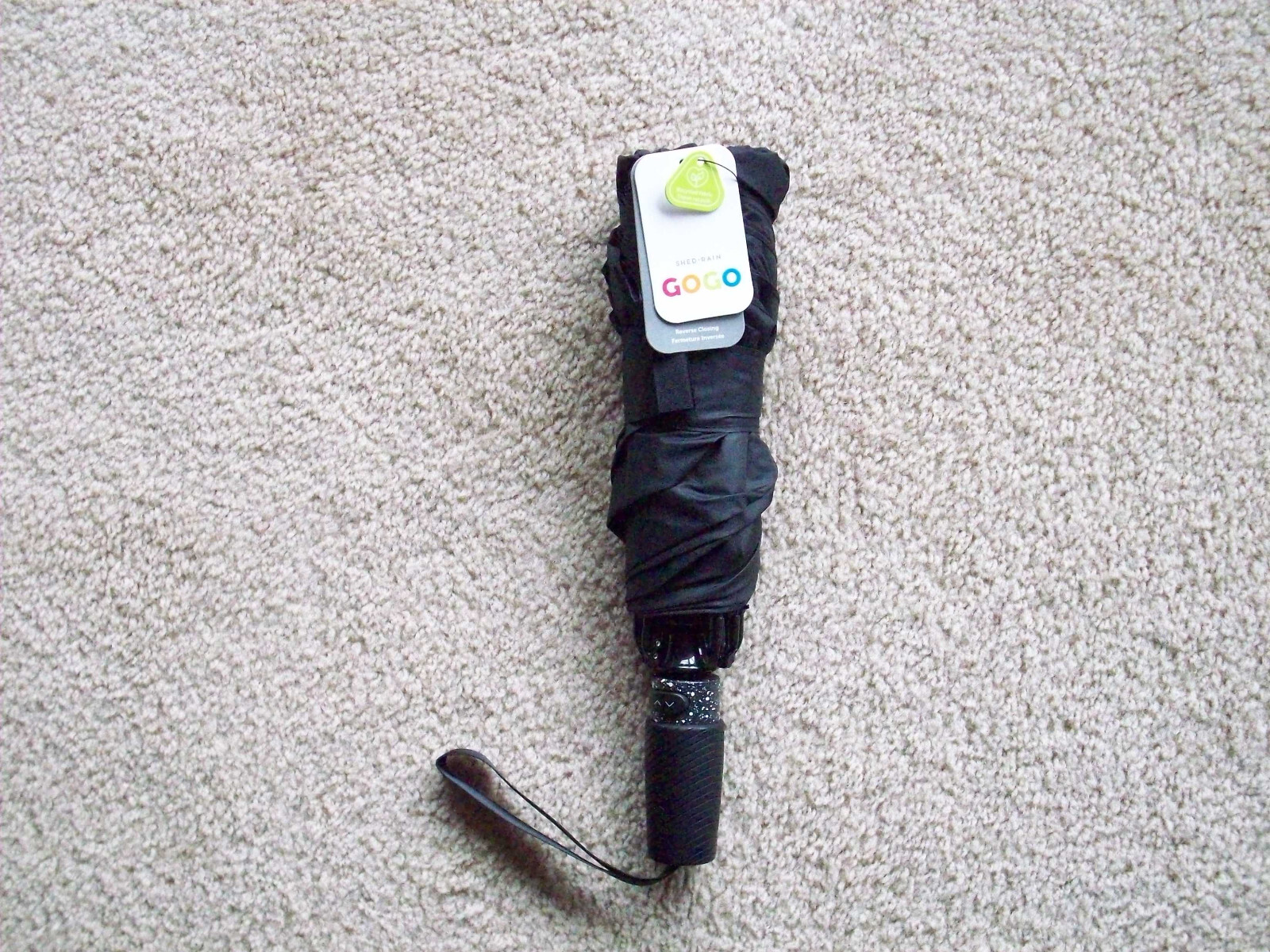 Black portable umbrella by GoGo, made from recycled material, new with tags