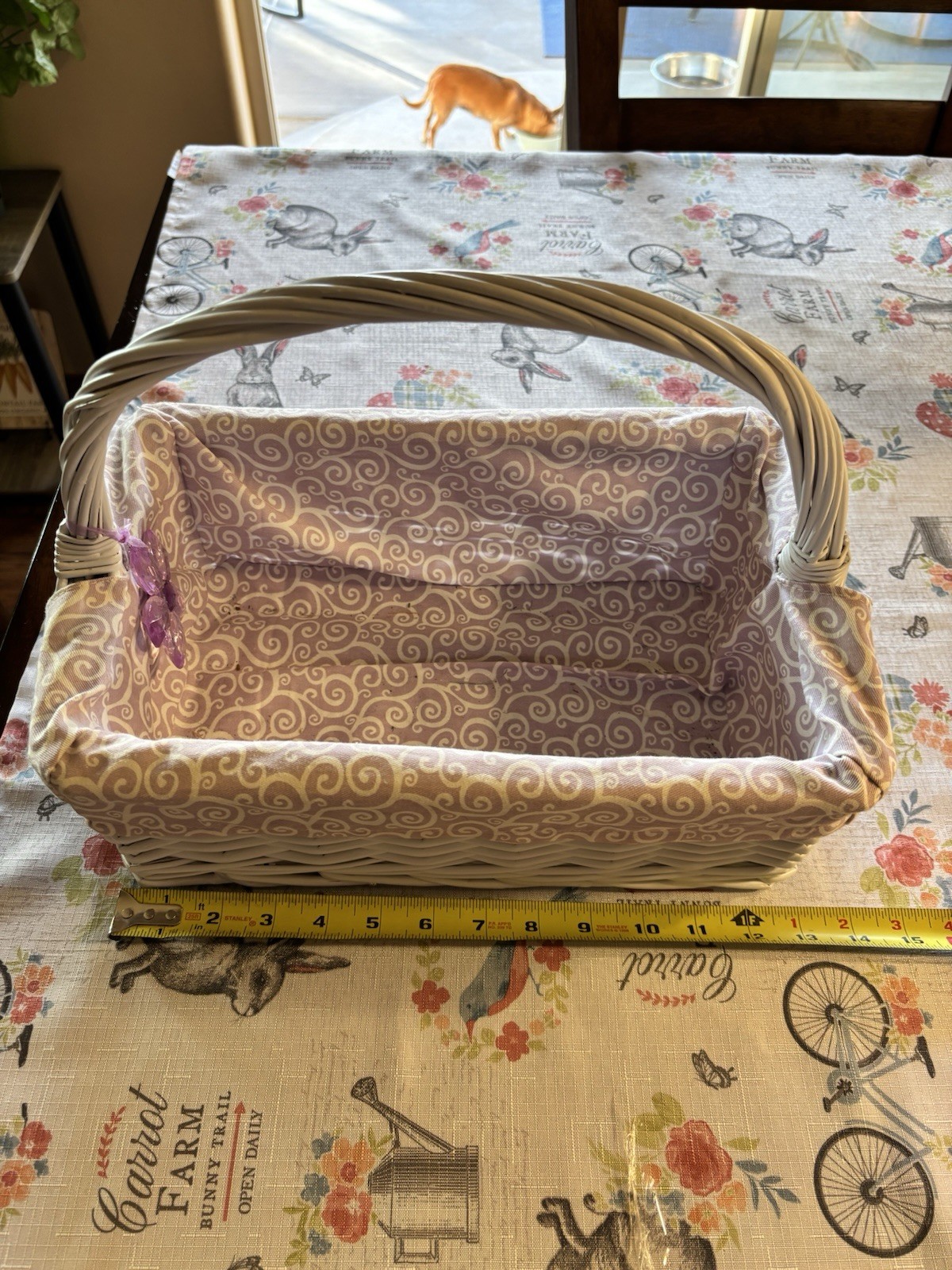 Vintage white wicker basket with a purple and white patterned fabric liner