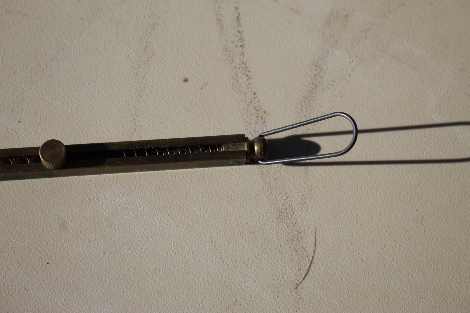 Brass straight-line percussion capper