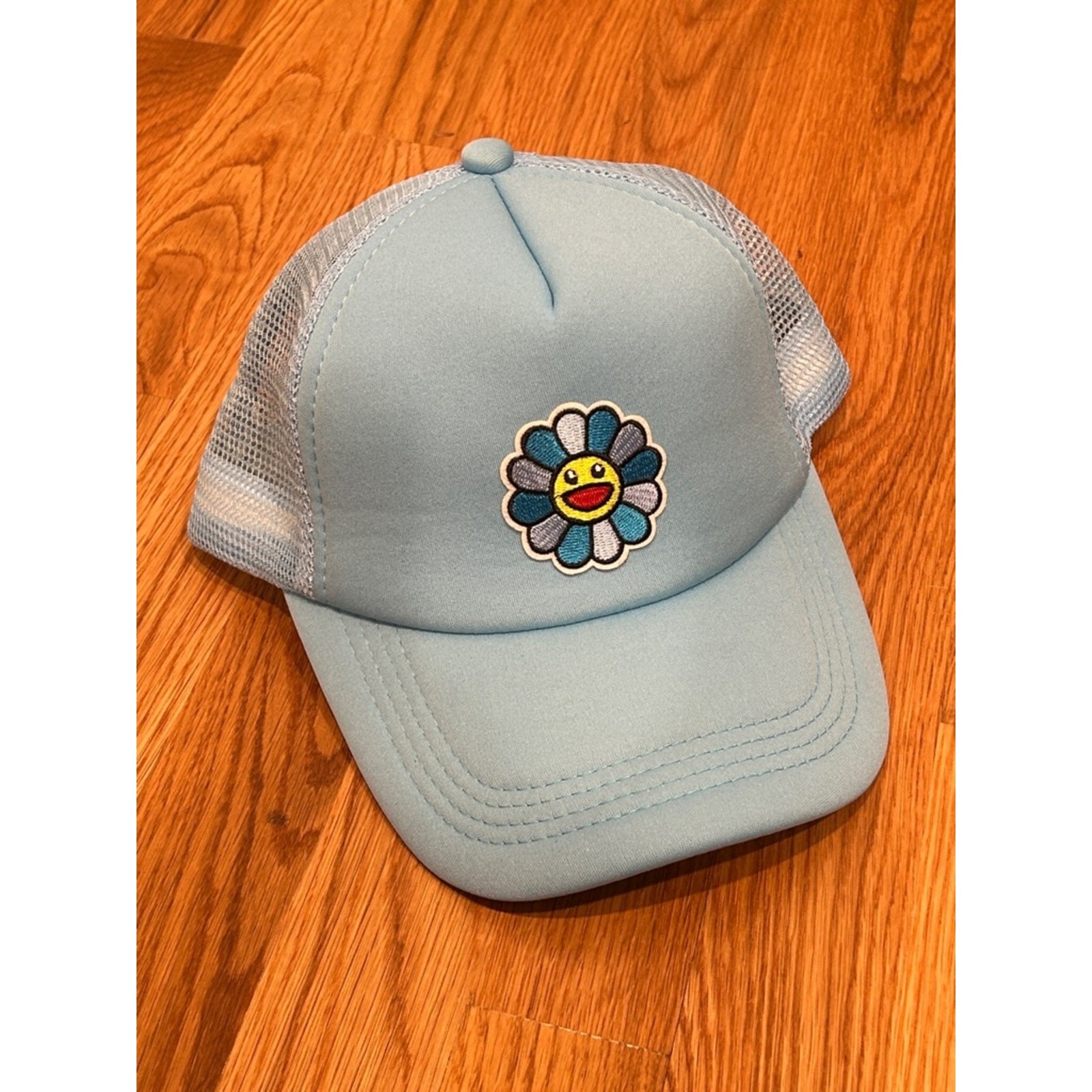 Light Blue Trucker Hat with Smiley Flower Patch adult one size adjustable