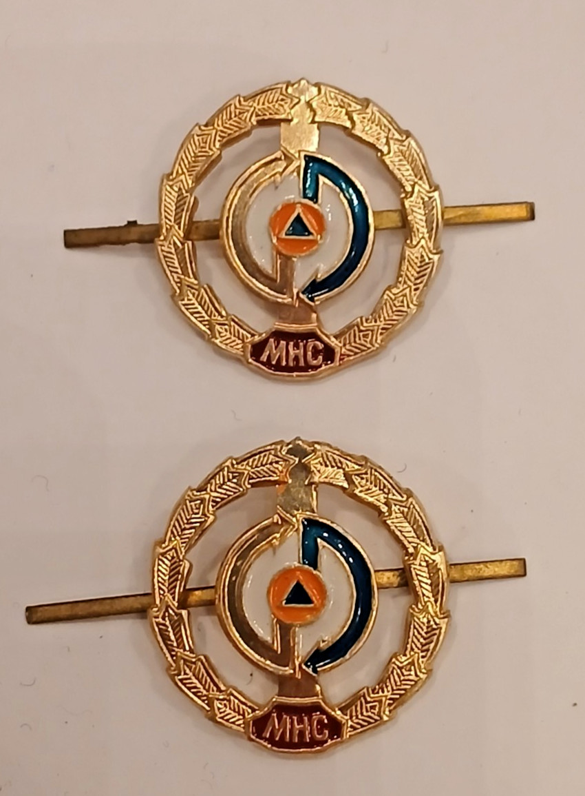 A pair of emblems of the Ministry of Emergencies of Ukraine
