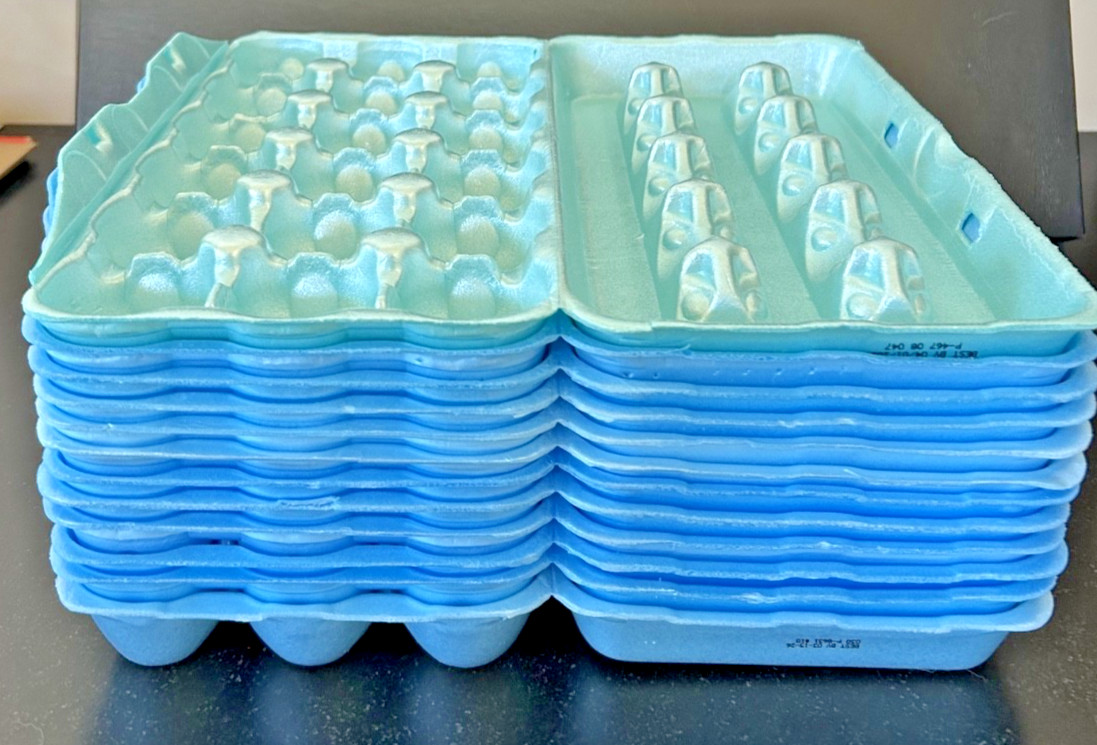 Twelve (12) styrofoam 18-count egg cartons, (11 blue, 1 green) Clean, Used