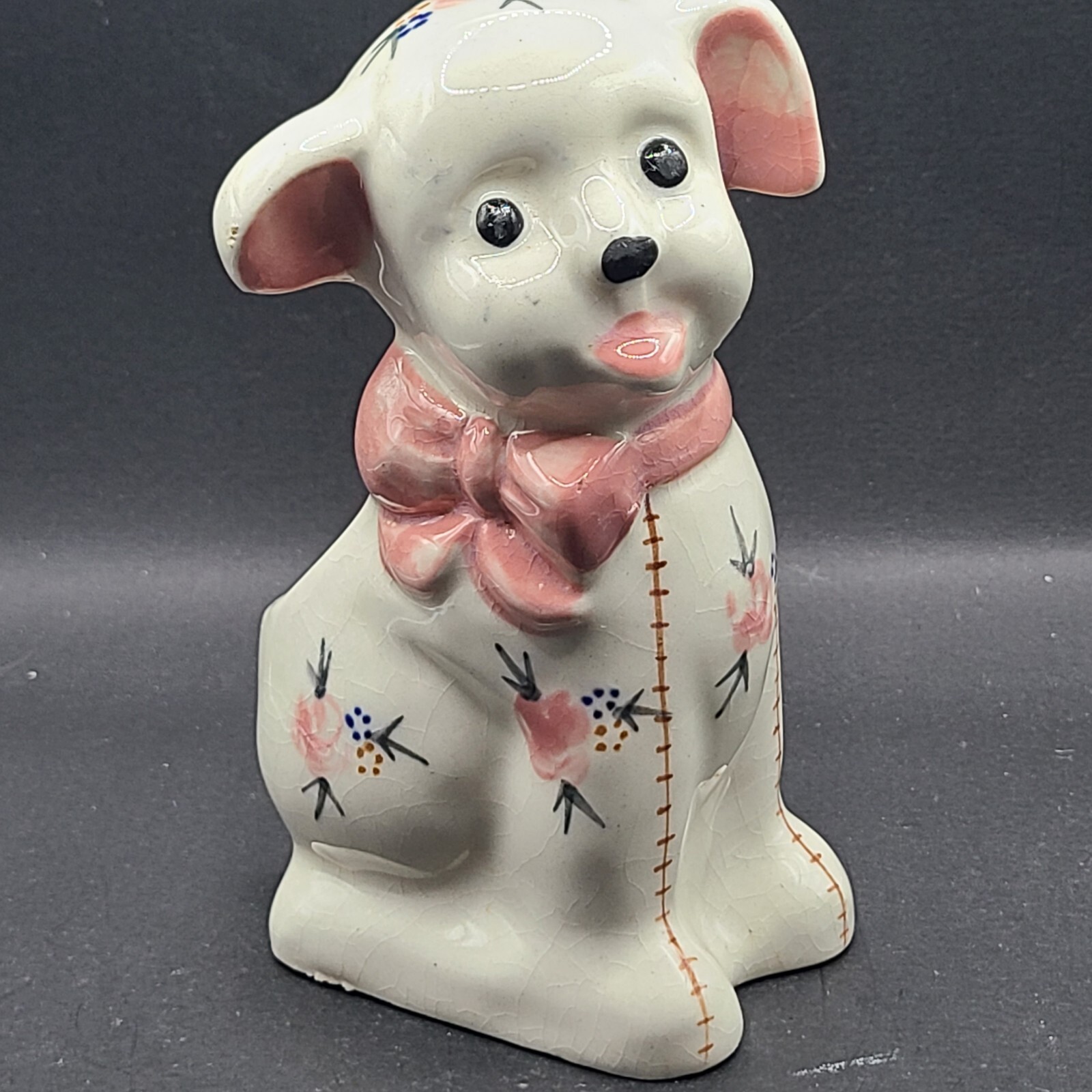 Planter ceramic dog w florals and stitching. Occ. Japan. Pink bow,brown stitches