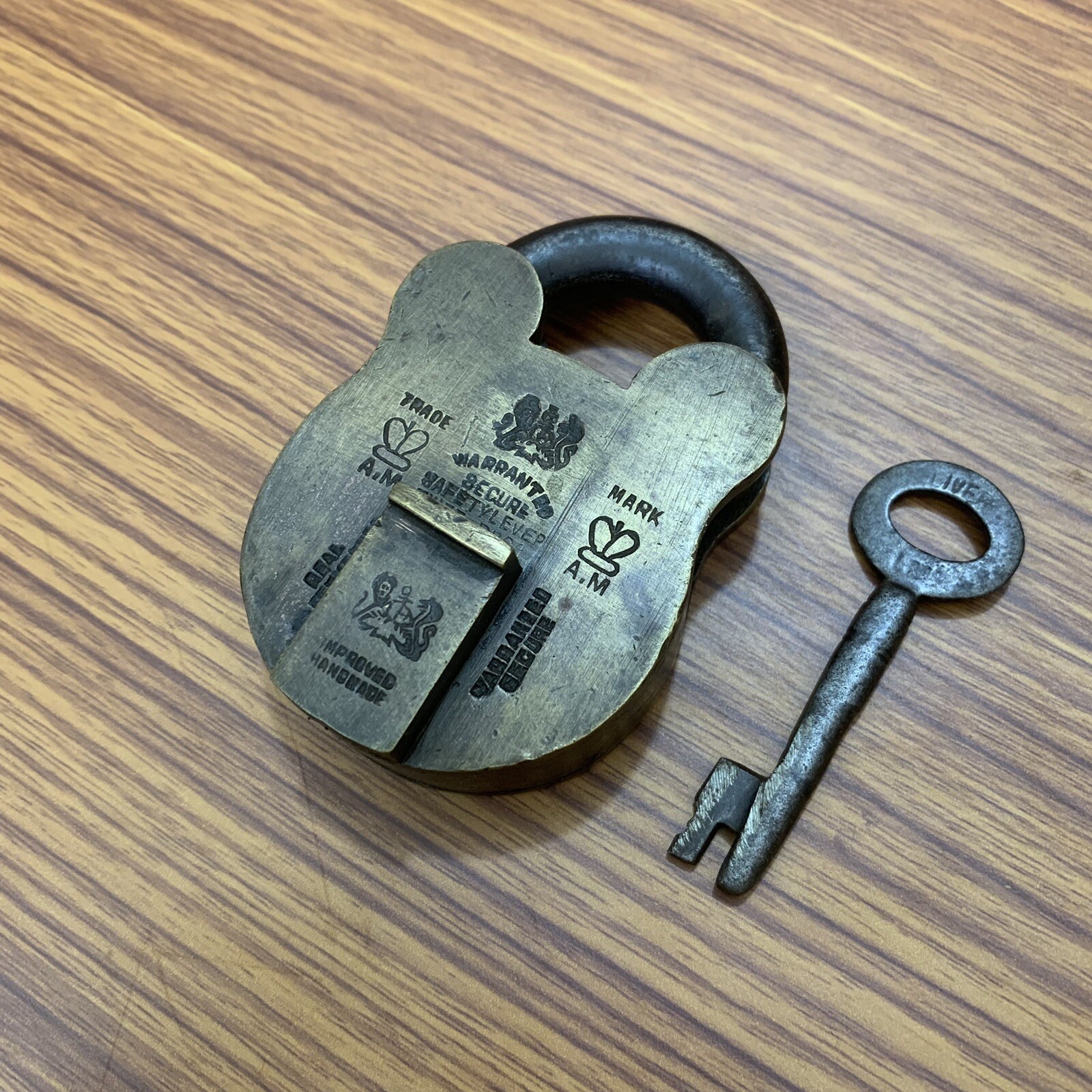 AN OLD OR ANTIQUE BRASS PADLOCK OR LOCK WITH KEY