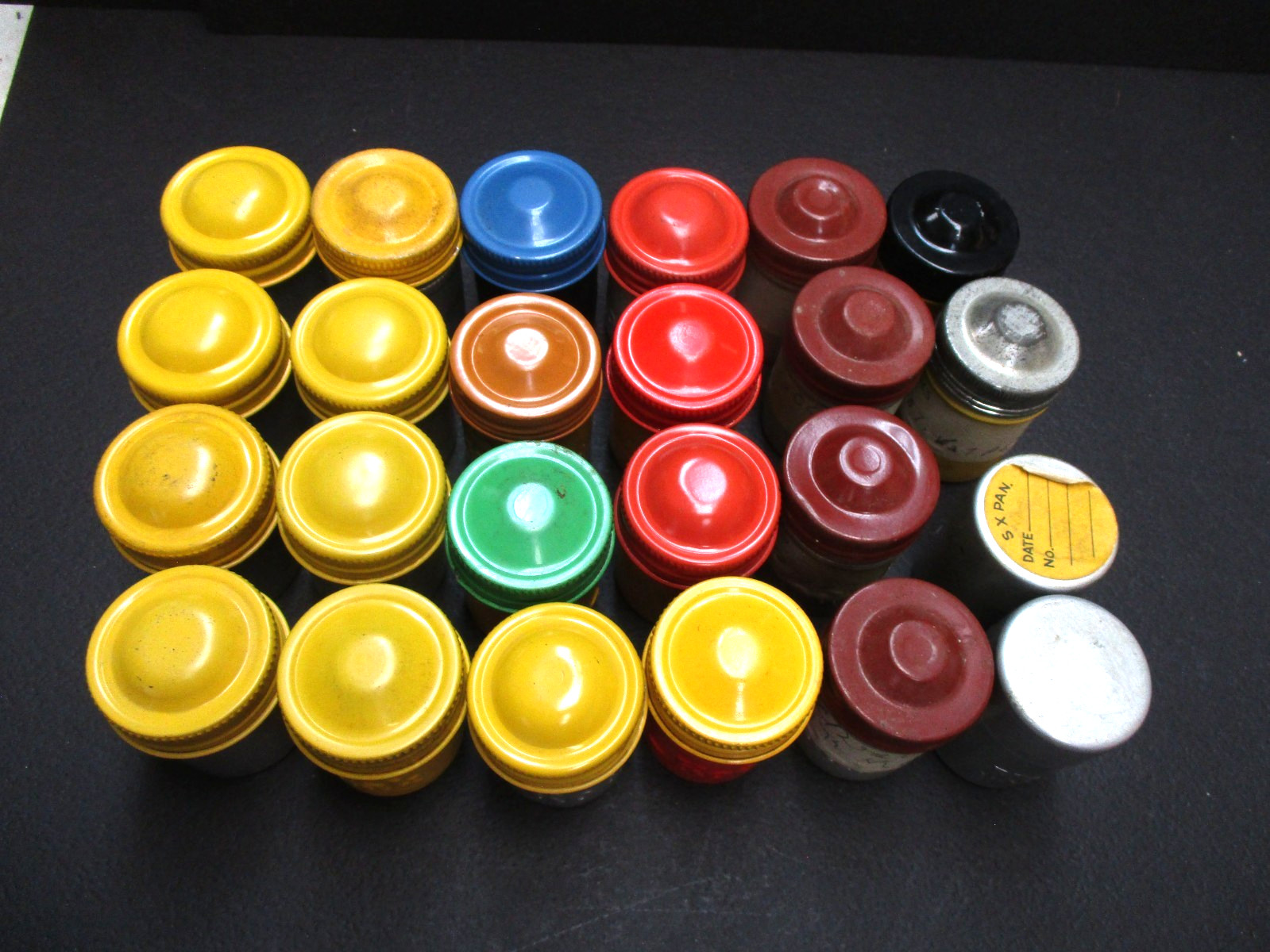 Lot 24 Kodak metal 35mm film canisters as shown.