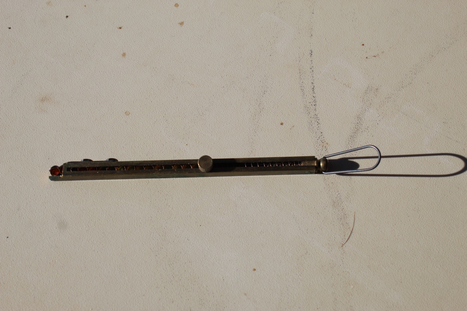 Brass straight-line percussion capper