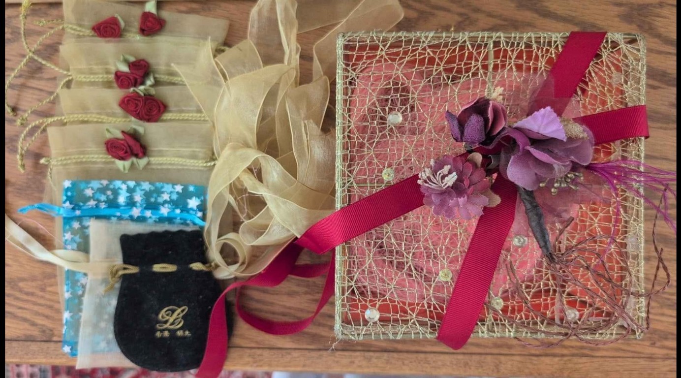 Red & golden gauze 6.5"x6.5"x3.5"h box with decorative ribbon and 7 bags