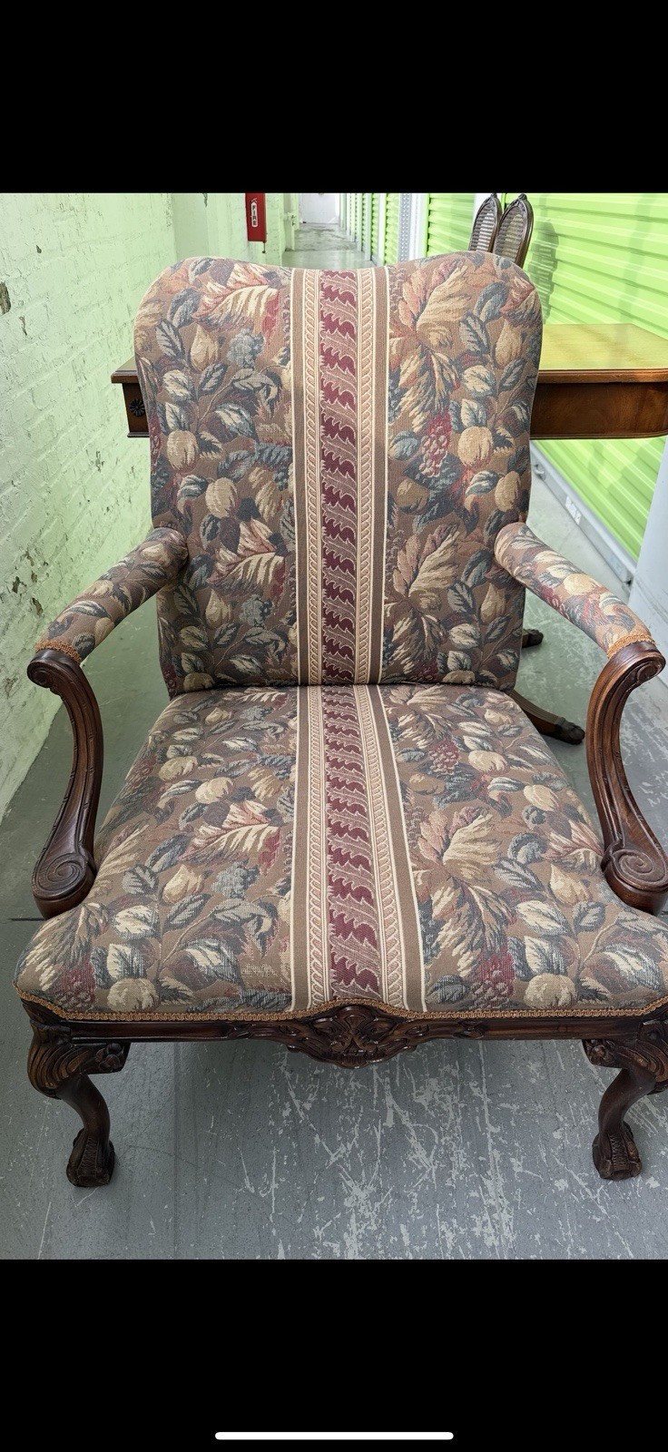 Georgian style carved mahogany armchair with its original floral upholstery.