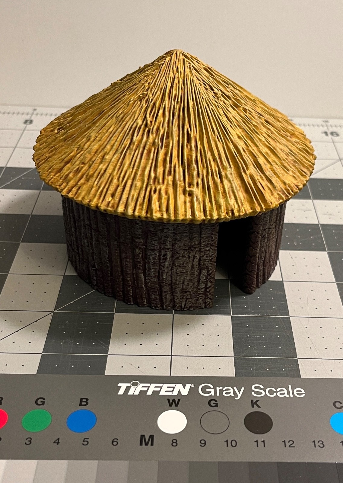 "primal hut" large round building with thatch roof tribal house