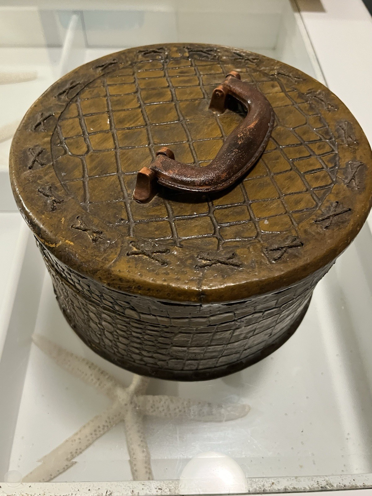 Wood basket with alligator pattern and silk lining.