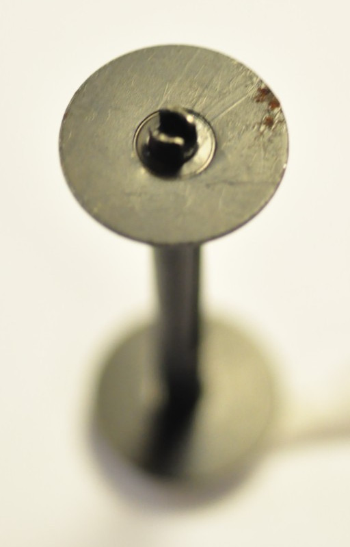 Size 127 empty black metal film spool.