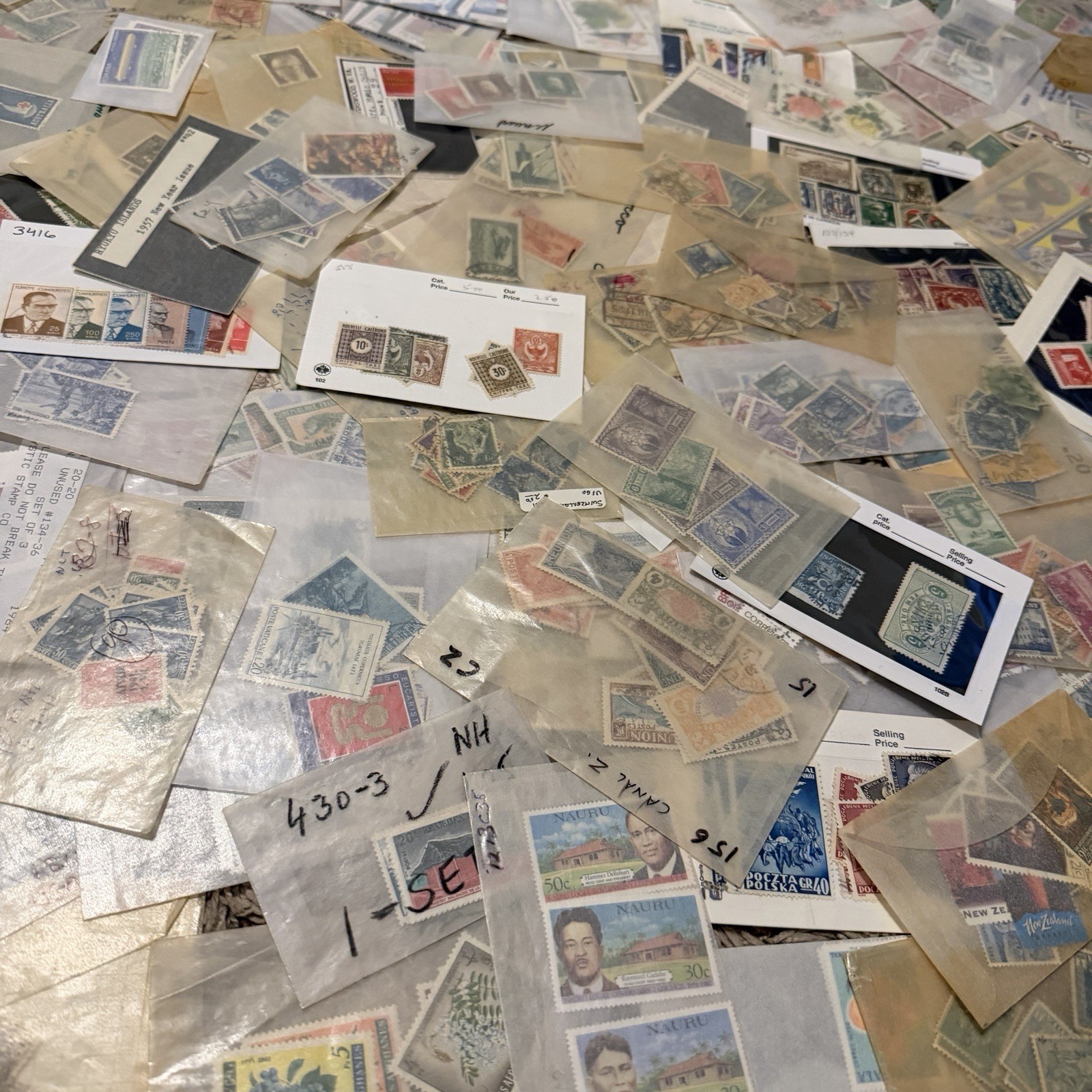 HUGE LOT OF INTERNATIONAL WORLD STAMPS IN GLASSINES ITALY SPAIN JAPAN SWEDEN ETC