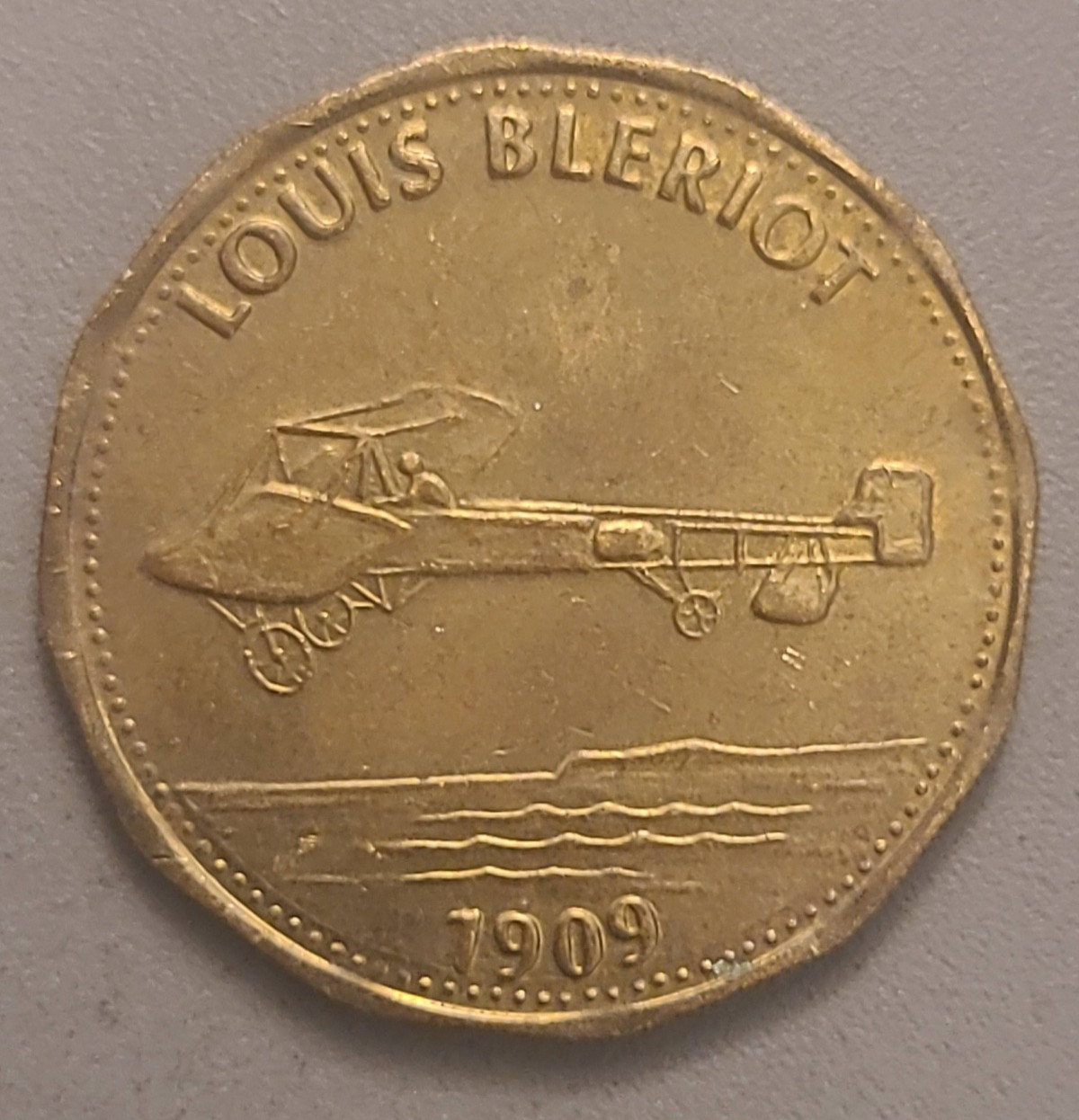 Vintage Shell Man in Flight Louis Bleriot 1909 Plane Metal Token - 	Dodecagonal