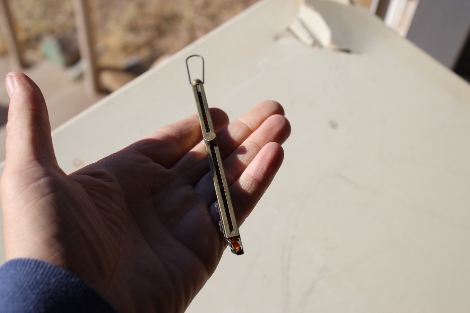 Brass straight-line percussion capper