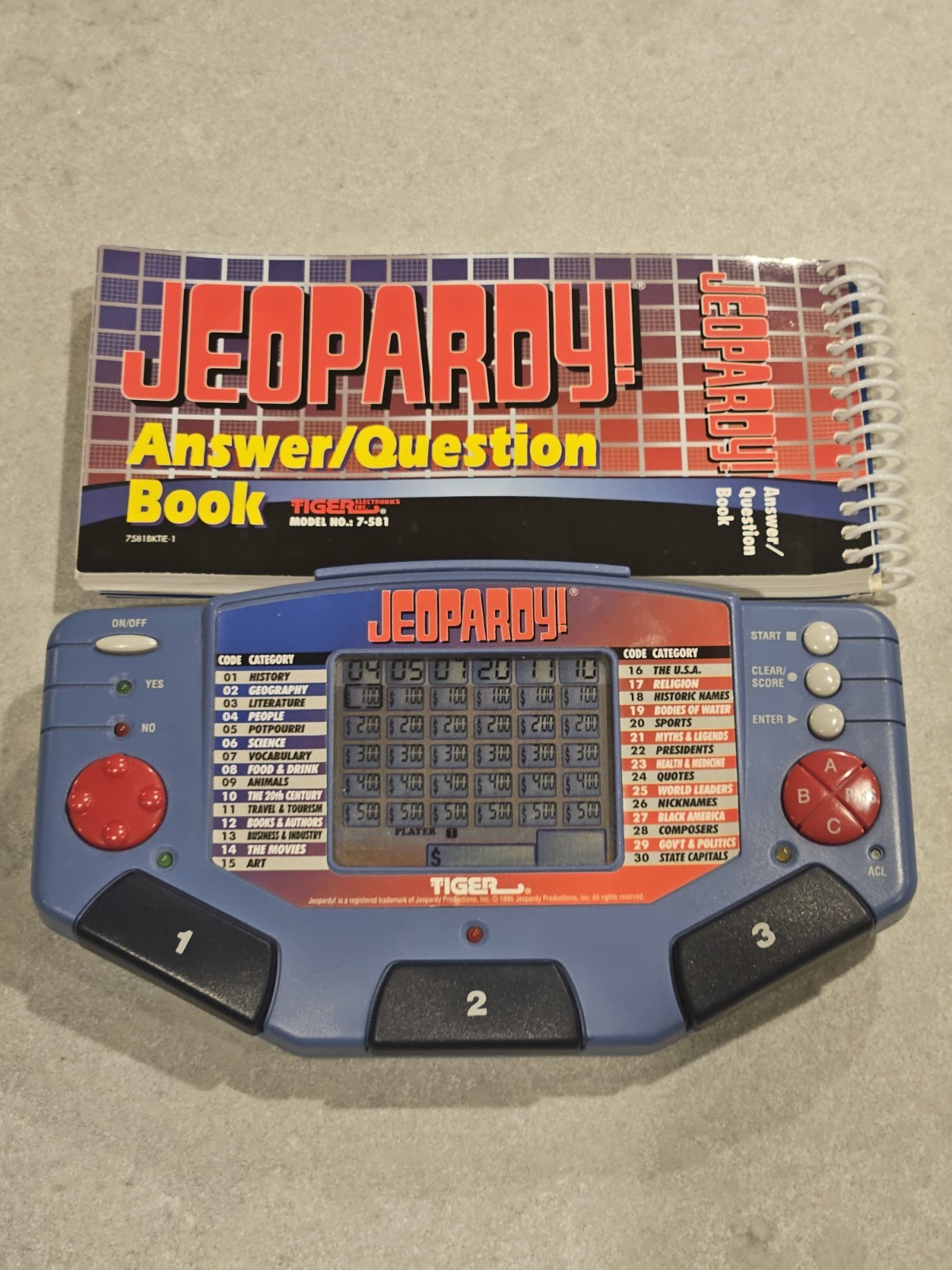 Tiger Electronics Jeopardy Hand Held Game 1995 with Answer Question Book