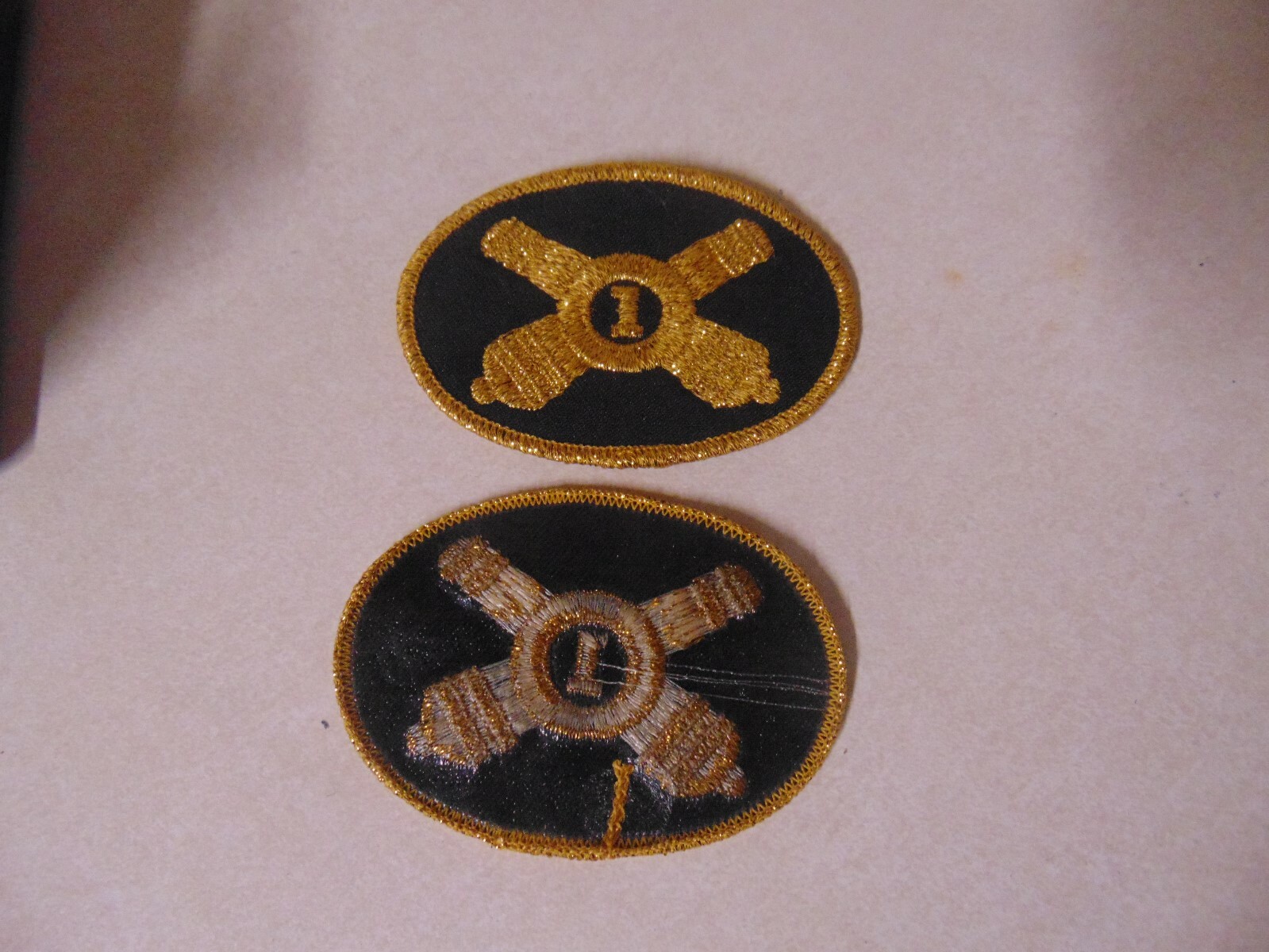 PATCH MILITARY OLDER UNSURE CROSSED CANNONS WITH 1 IN MIDDLE GOLD AND BLACK