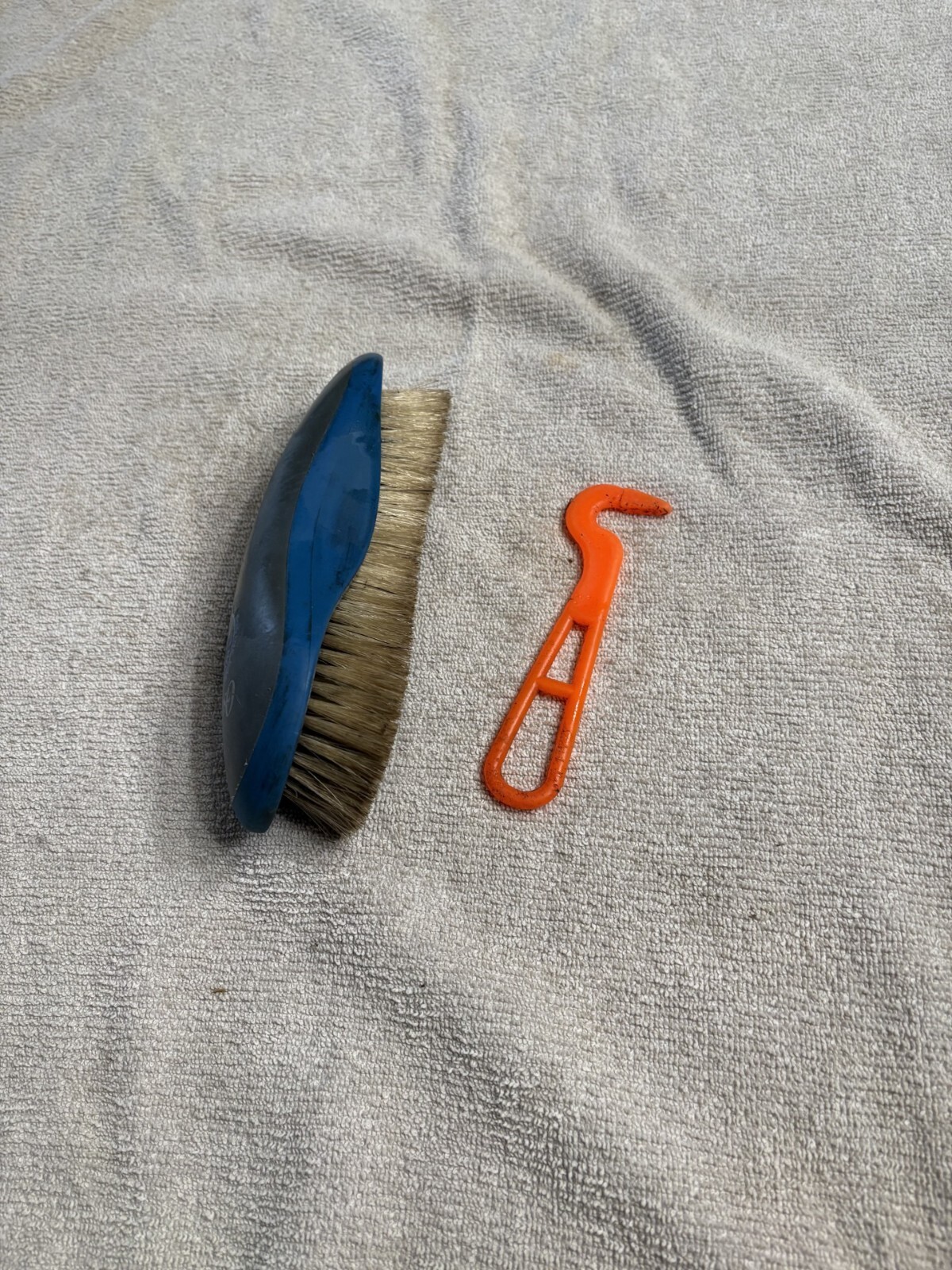 horse brush and a hoofpick