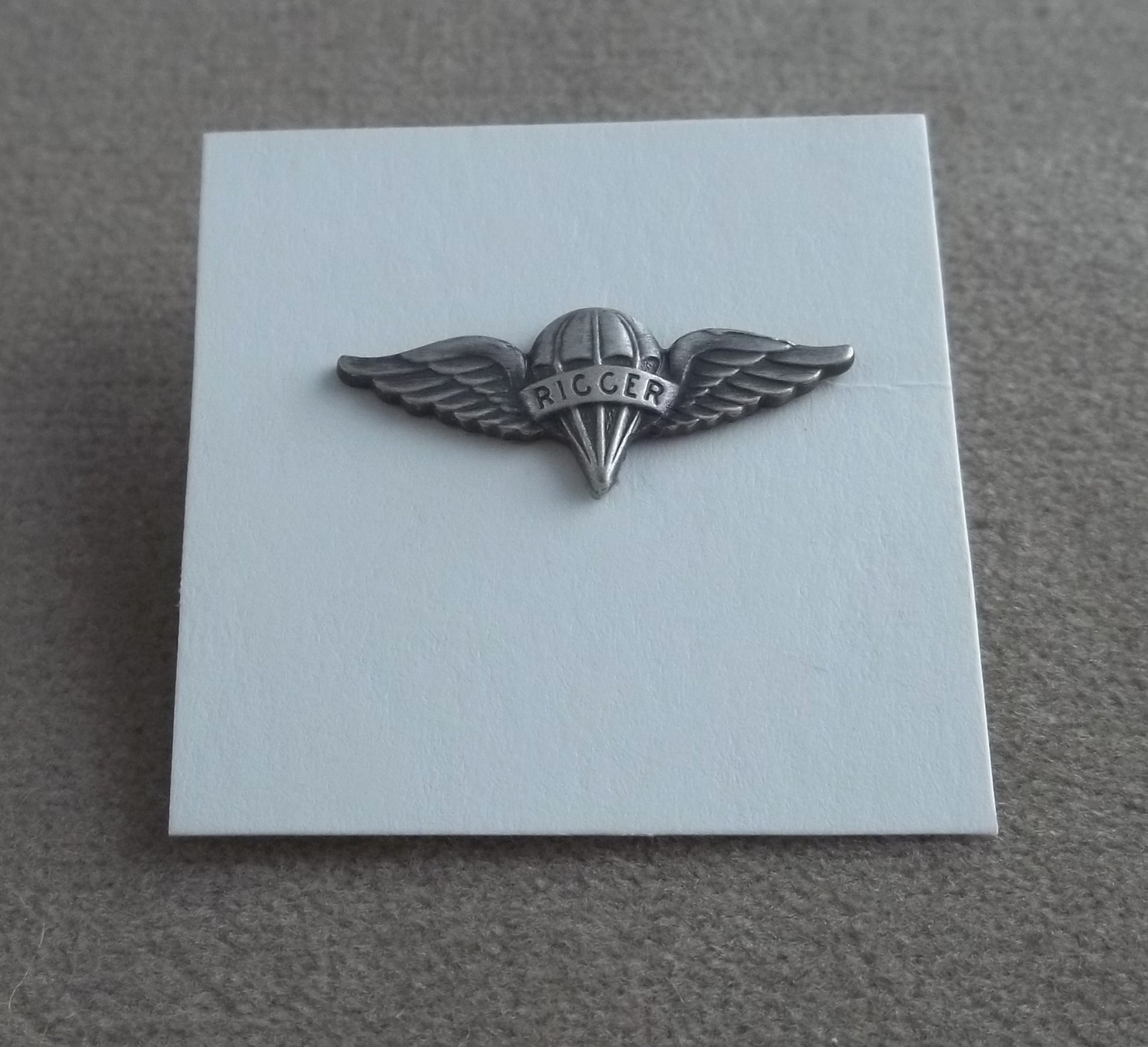 US Army Miniature Parachute Rigger Badge - Silver Oxide Finish NOS