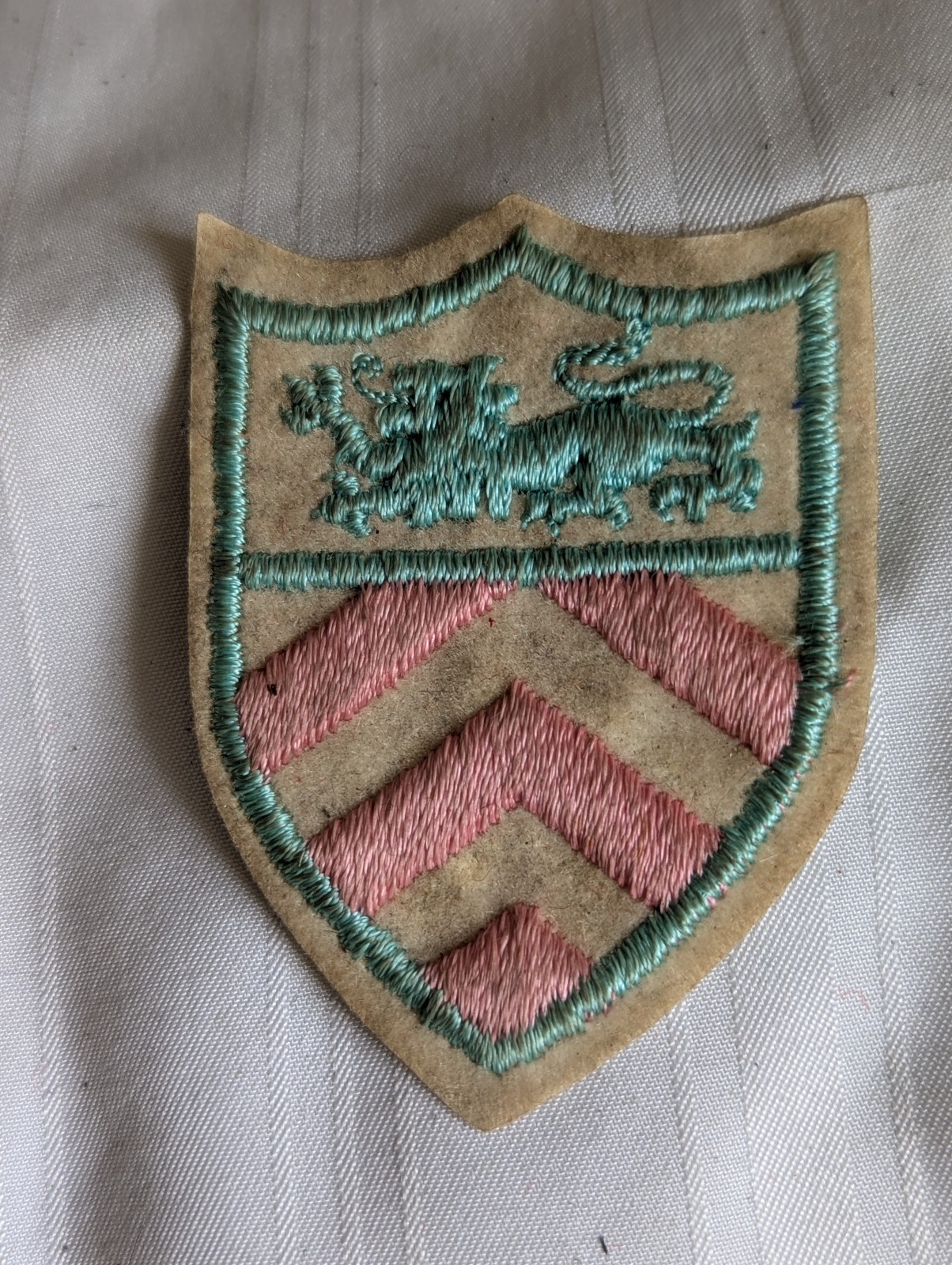 Shield shaped pink aqua blue lion embroidered patch 2.75" long