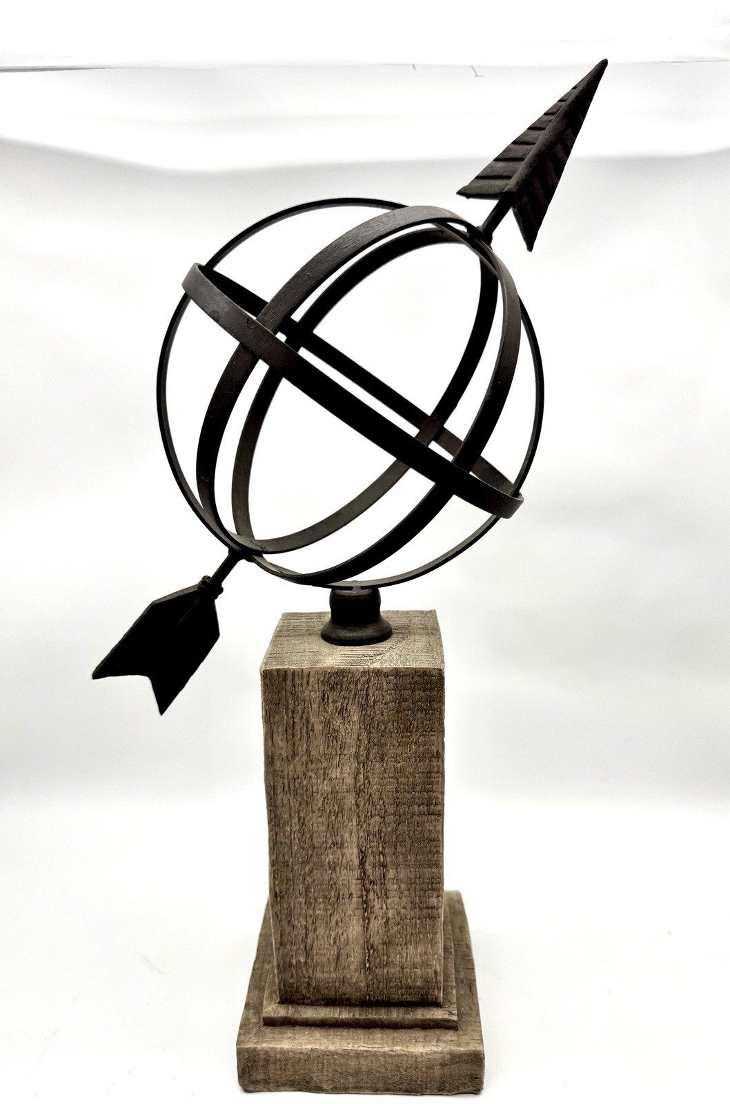 Decorative Iron Armillary Sphere with Arrow on Weathered Wood Pedestal