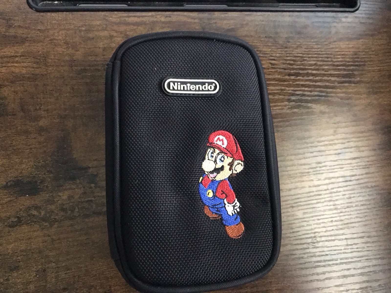Nintendo Case With Super Mario Embroidered On The Front Of Case