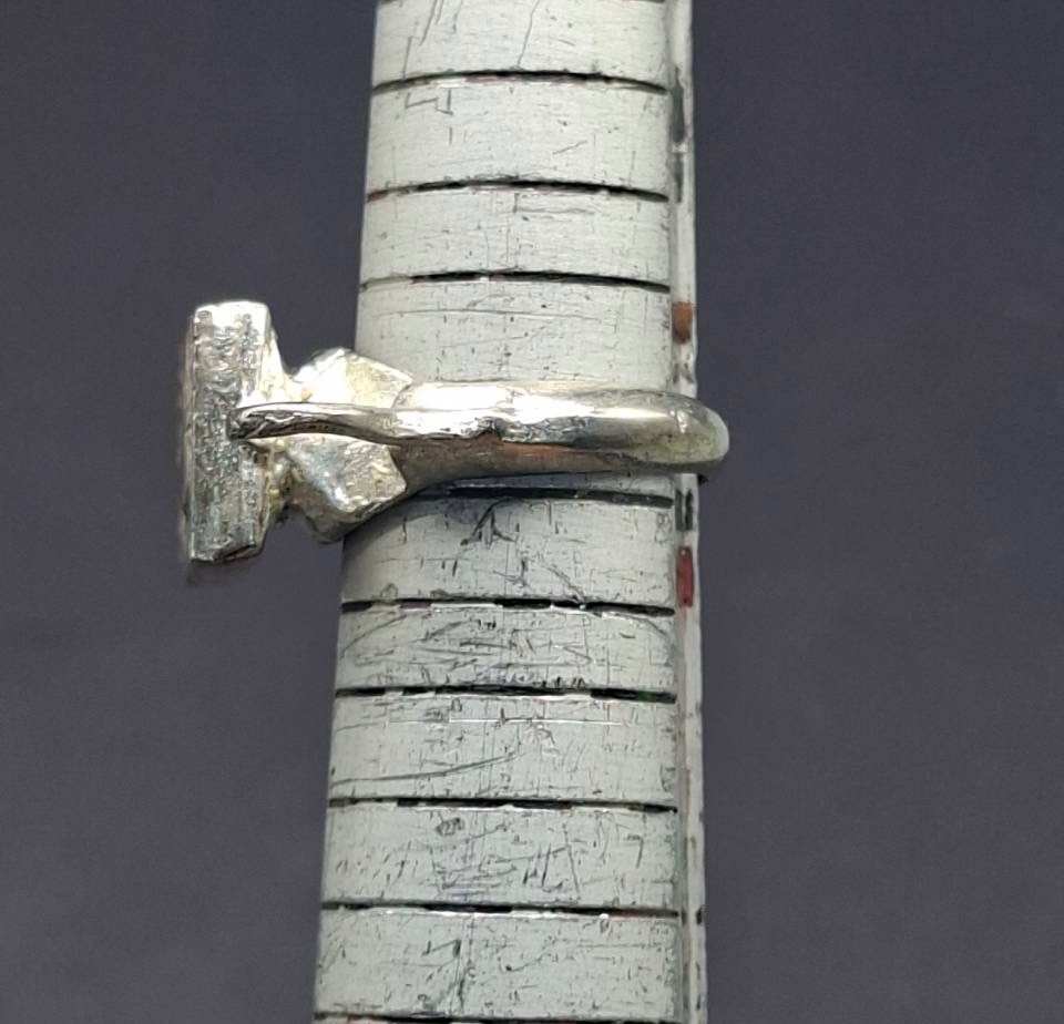 vintage-style ring featuring a square, textured face plate Roman Greco coin