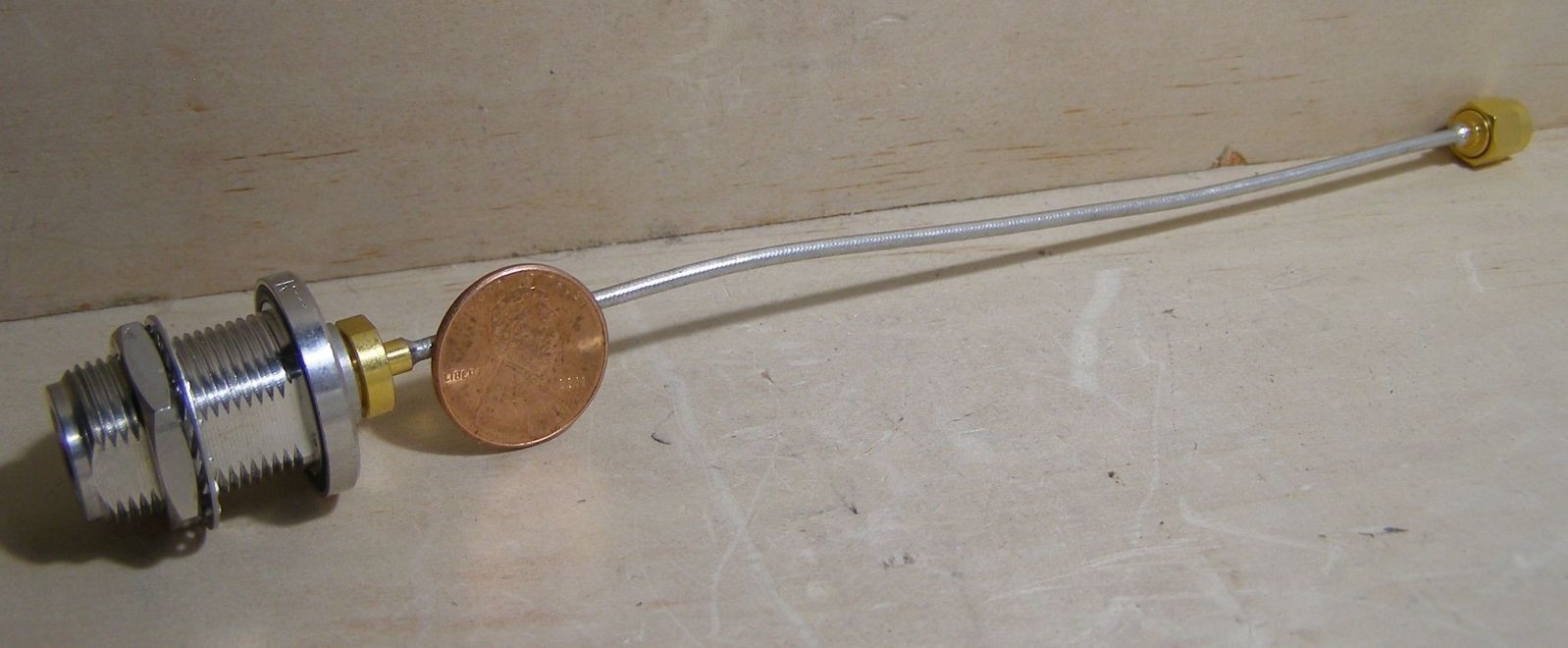 SUHNER BULKHEAD ADAPTER WITH FLEX CABLE INTO SMA. APPROX. 7-1/2".