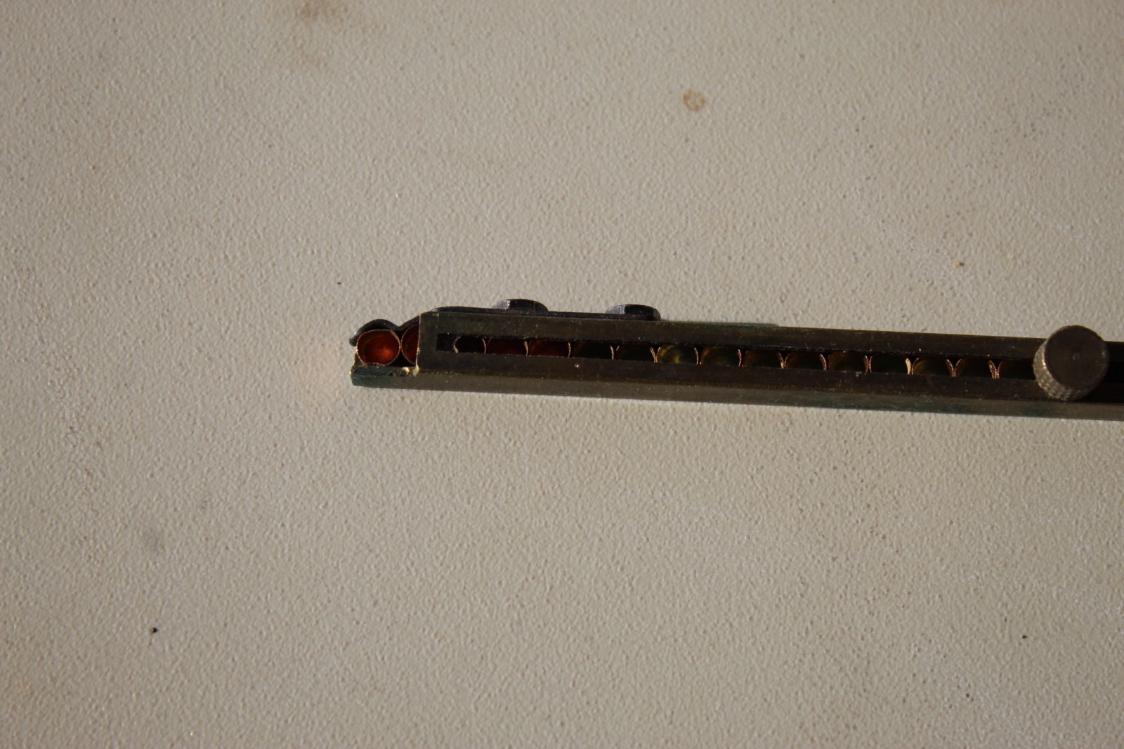 Brass straight-line percussion capper