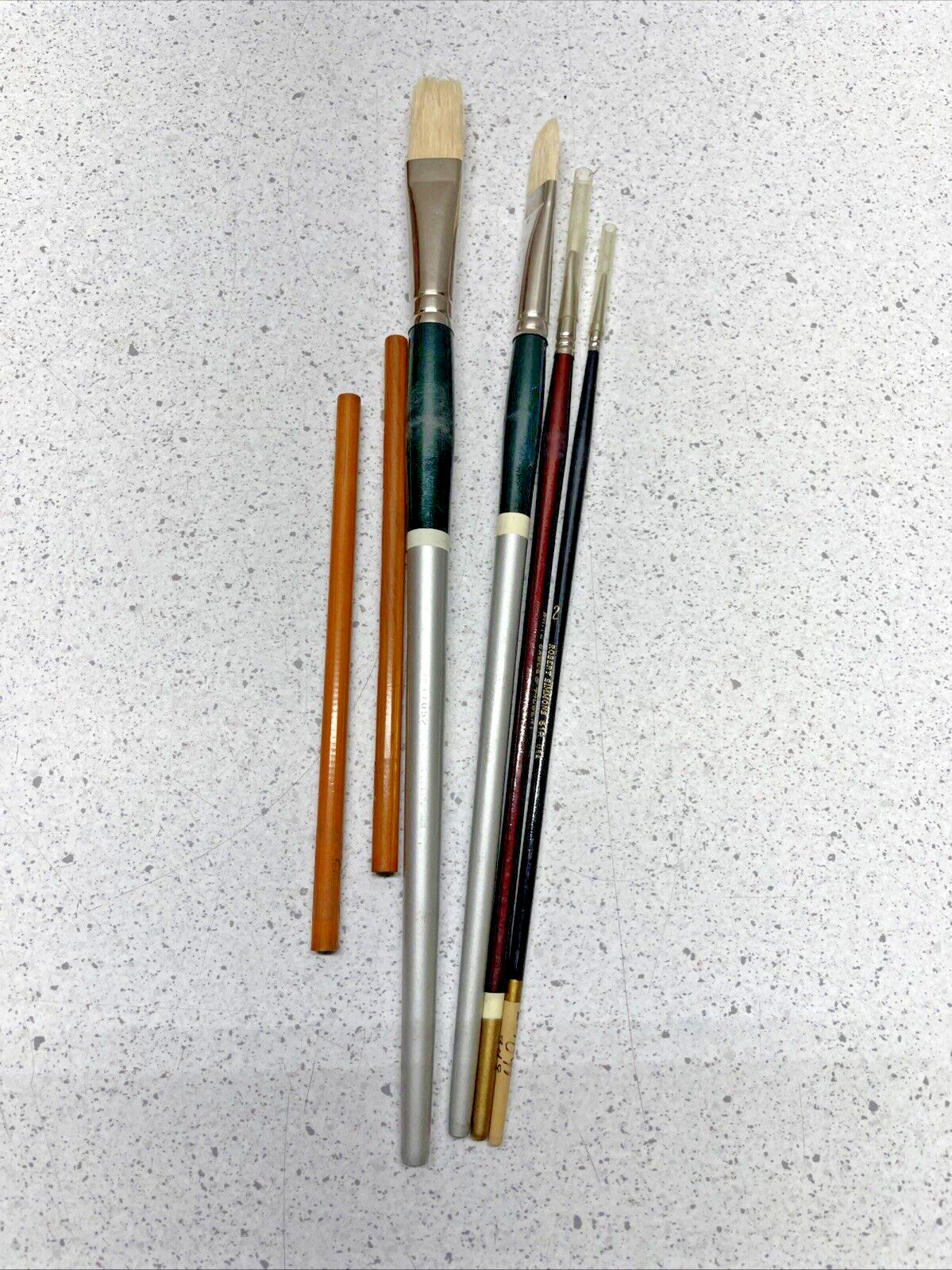 Small Assortment of Paint Brushes and Charcoal Pencils