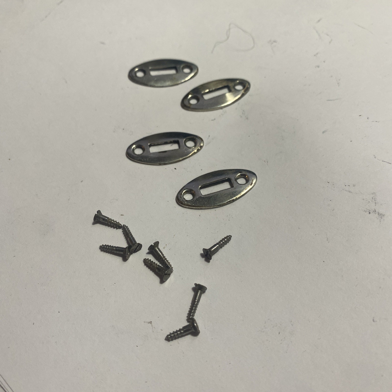 Four (4) Steel Wedge Plates and Screws from a Mountain Rifle Muzzleloader.