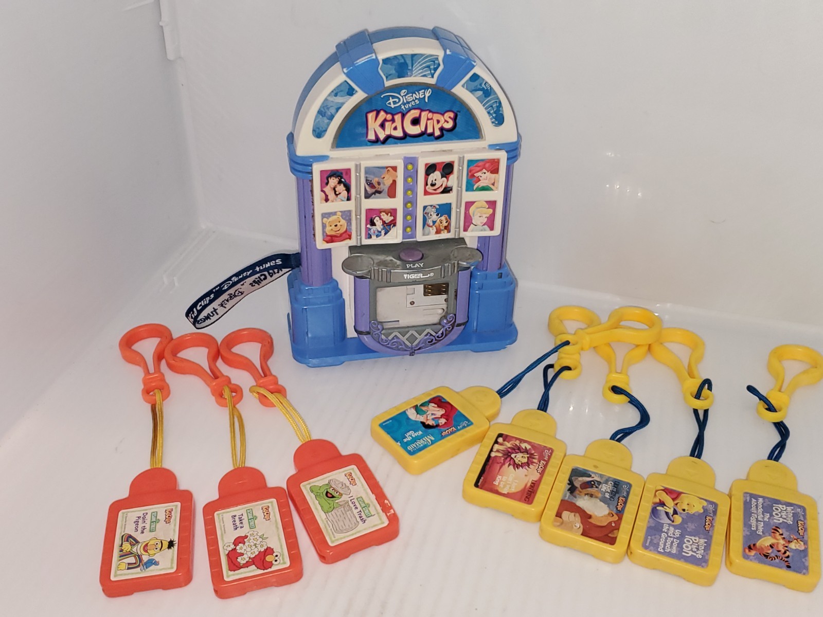 TIGER  Disney Tunes Kid Clips 2002 Radio Audio Player w/8 Song Tunes Cartridges.