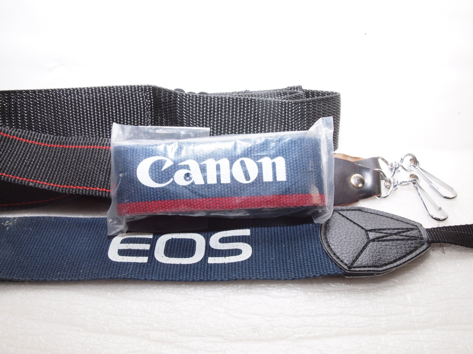 Canon camera straps- 1 new in package includes Canon EOS wide strap.