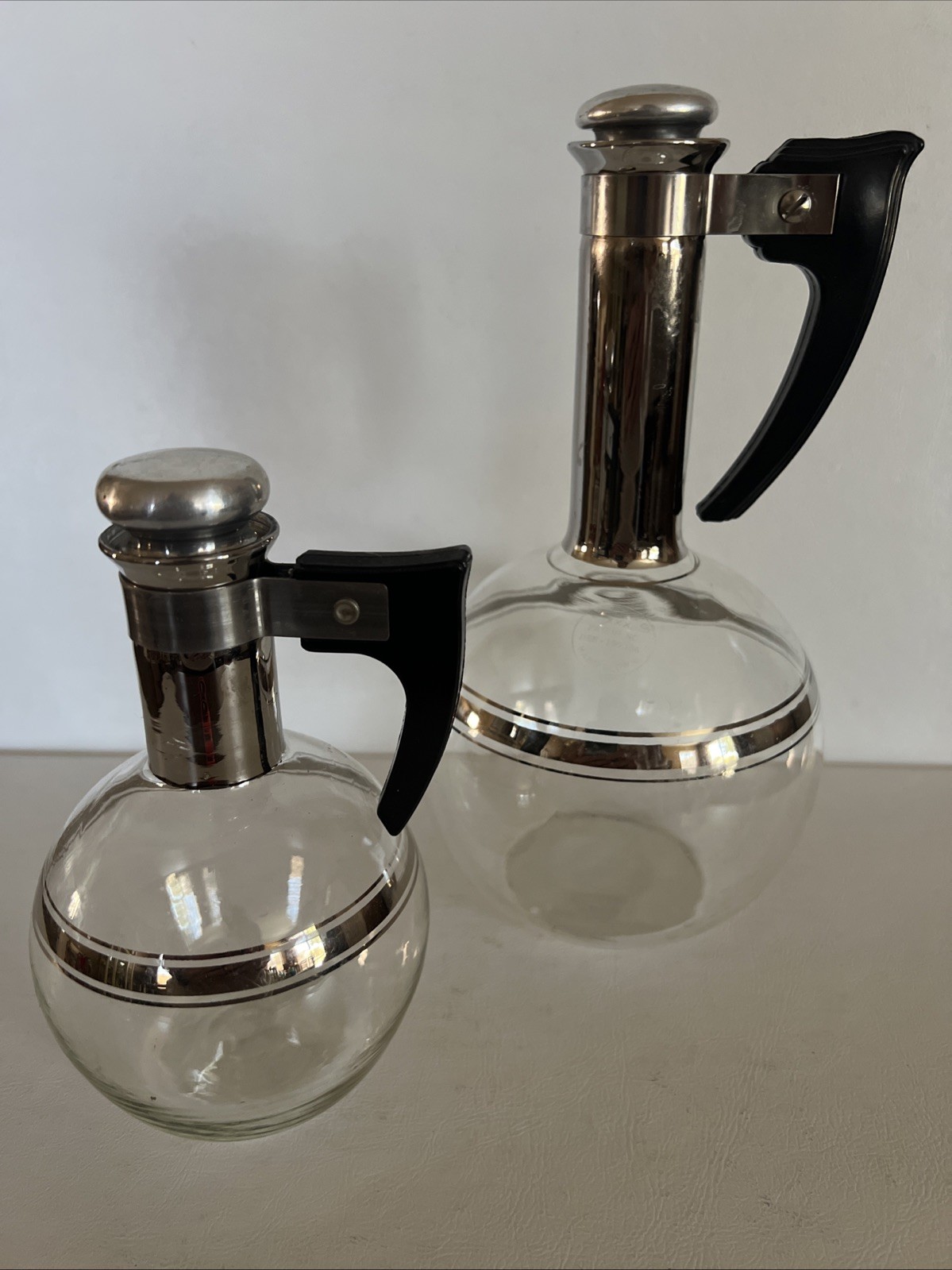 2 Vintage Inland Glass Carafes MCM Coffee 1 and 2 Cup Silver Tone w/Stoppers