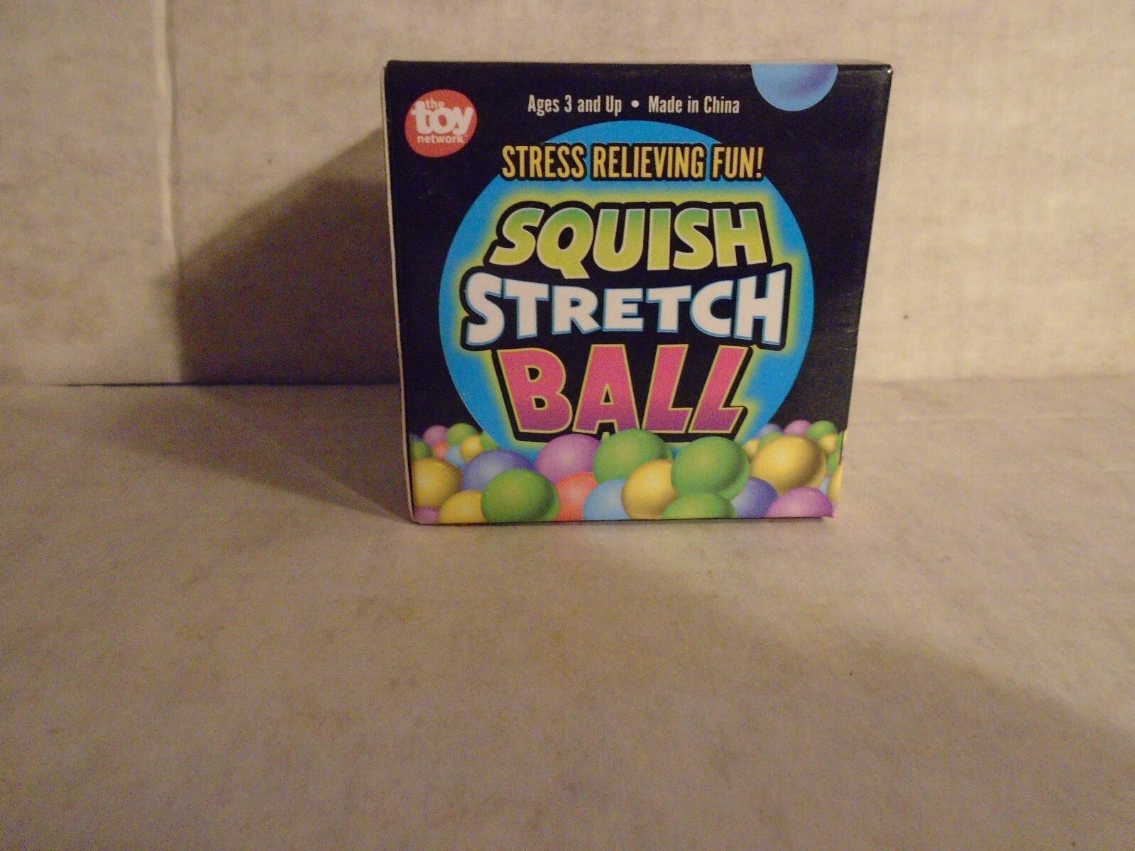Squish Stretch Ball- Green stress relieving fun. In box, stretch/squeeze, squish