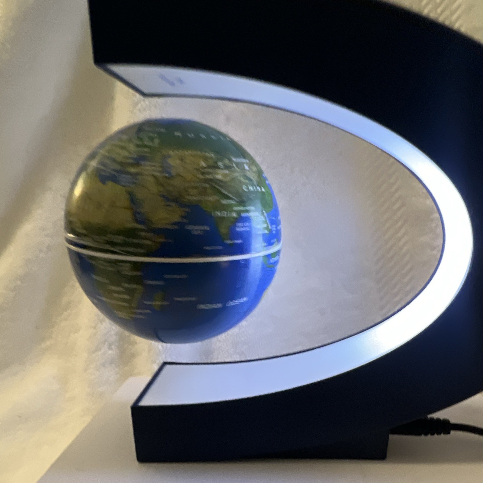 Modern Floating Tabletop Globe, Blue/Green Rotating Design, Black Base, Corded
