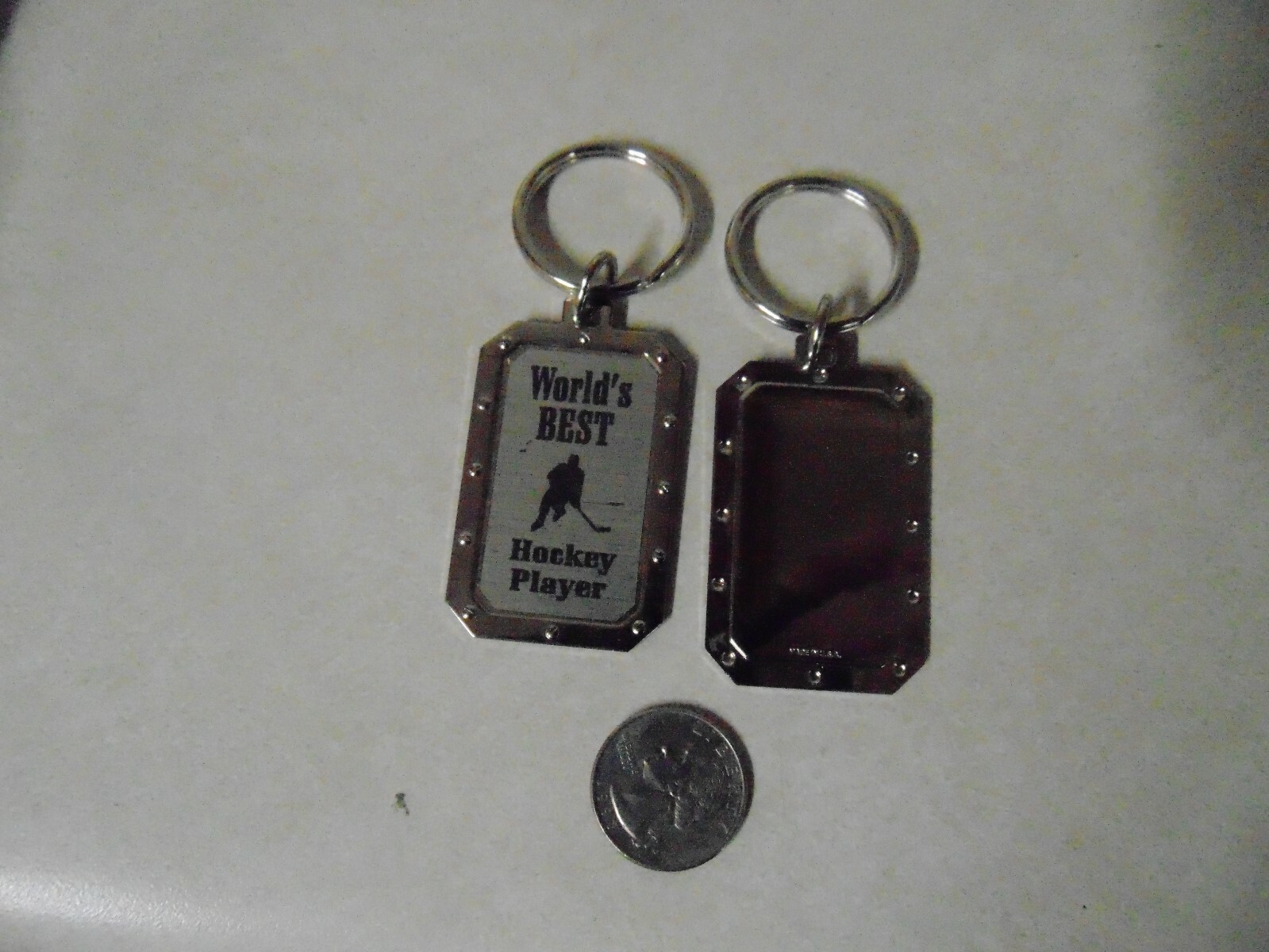 DOG TAG SHAPED KEY CHAIN WORLDS BEST HOCKEY PLAYER ABOUT 2 INCHES