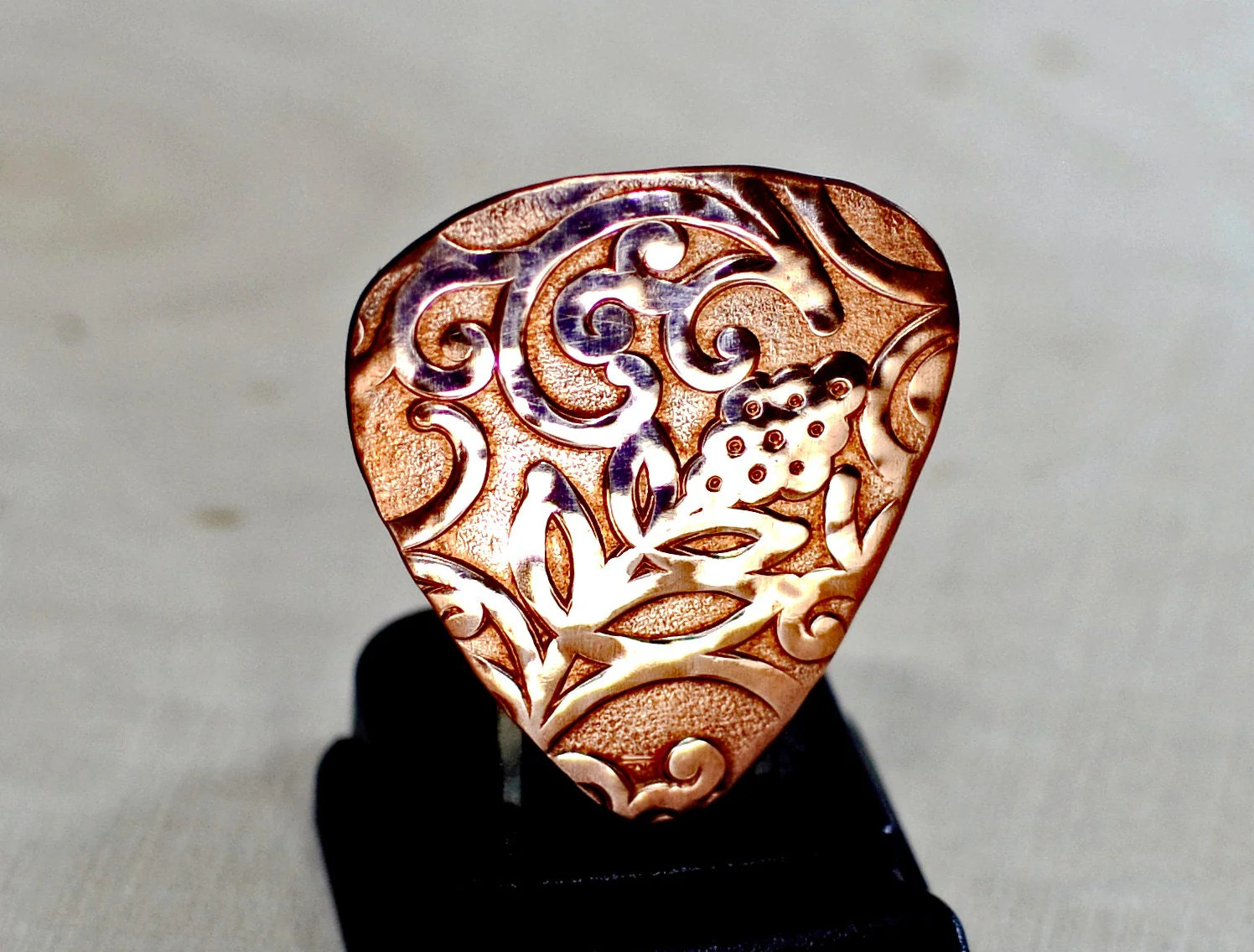 Rococo copper guitar pick with vines