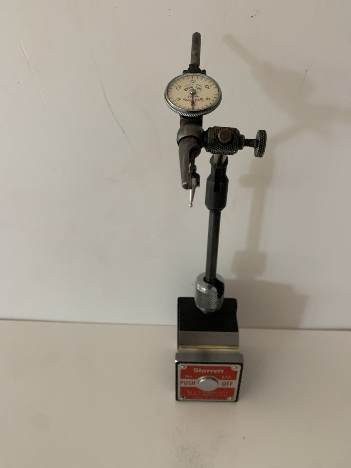 Starrett No. 657A magnetic base with No. 711 last word indicator.